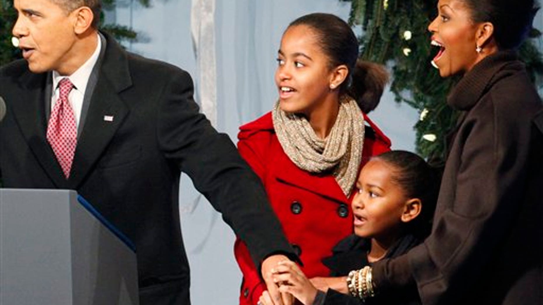 President Barack Obama, first lady Michelle Obama and daughters Sasha and Malia help to light the National Christmas Tree, Thursday, Dec. 3, 2009, in Washington. (AP Photo/Haraz N. Ghanbari)