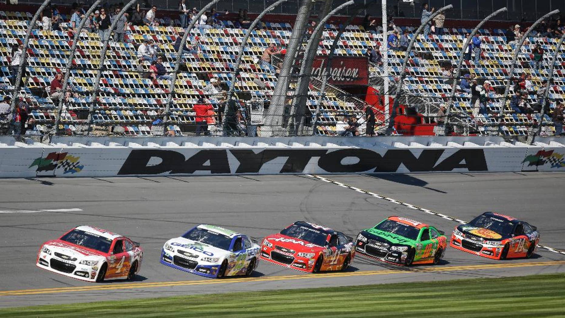 Cars qualifying for the Daytona 500 NASCAR Sprint Cup Series auto race, from left to right, Kevin Harvick (4), Casey Mears (13), Kurt Busch (41), Danica Patrick (10) and Tony Stewart (14) runs laps at Daytona International Speedway, Sunday, Feb. 15, 2015, in Daytona Beach, Fla. (AP Photo/John Raoux)