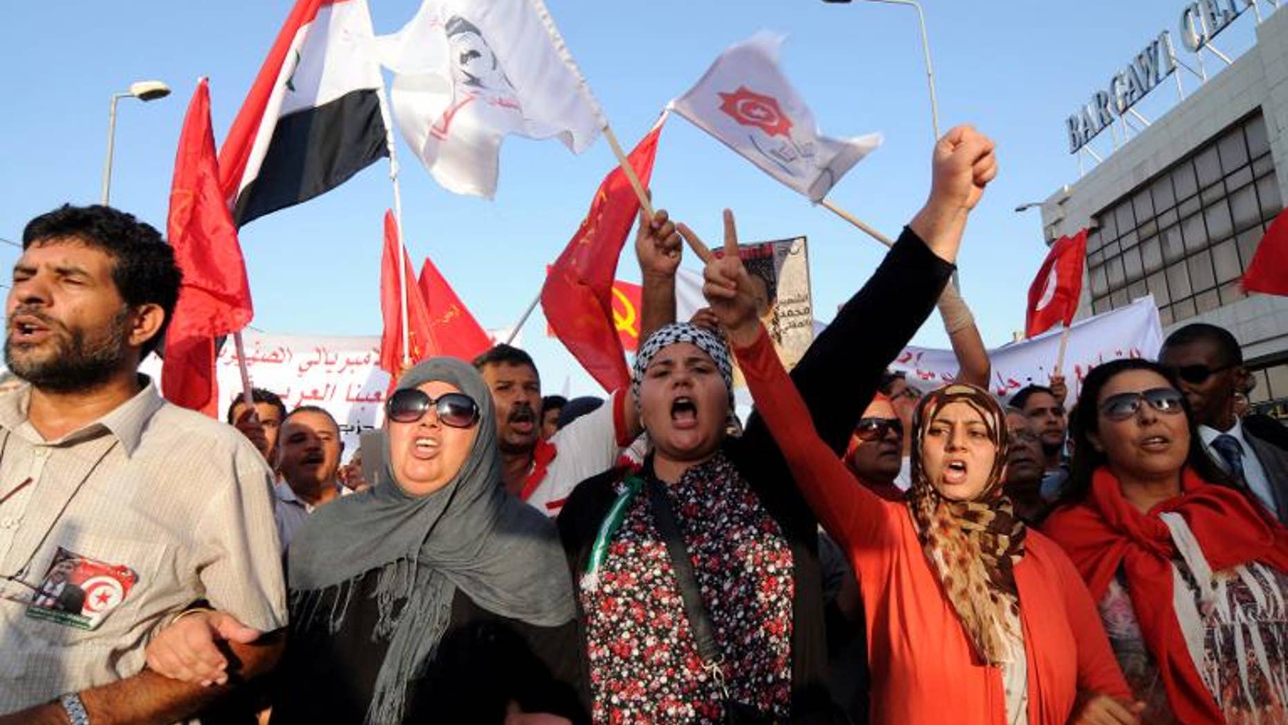 Tunisians march outside the National Assembly in Tunis on September 7, 2013.