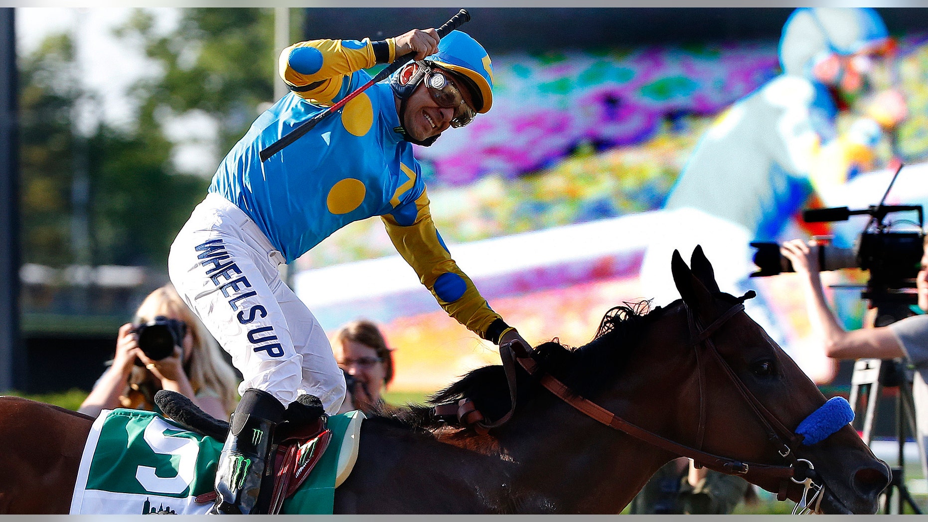 Victor Espinoza reacts after crossing the finish line with American Pharoah to win the 147th running of the Belmont Stakes horse race at Belmont Park, Saturday, June 6, 2015, in Elmont, N.Y. American Pharoah is the first horse to win the Triple Crown since Affirmed won it in 1978. (AP Photo/Kathy Willens)