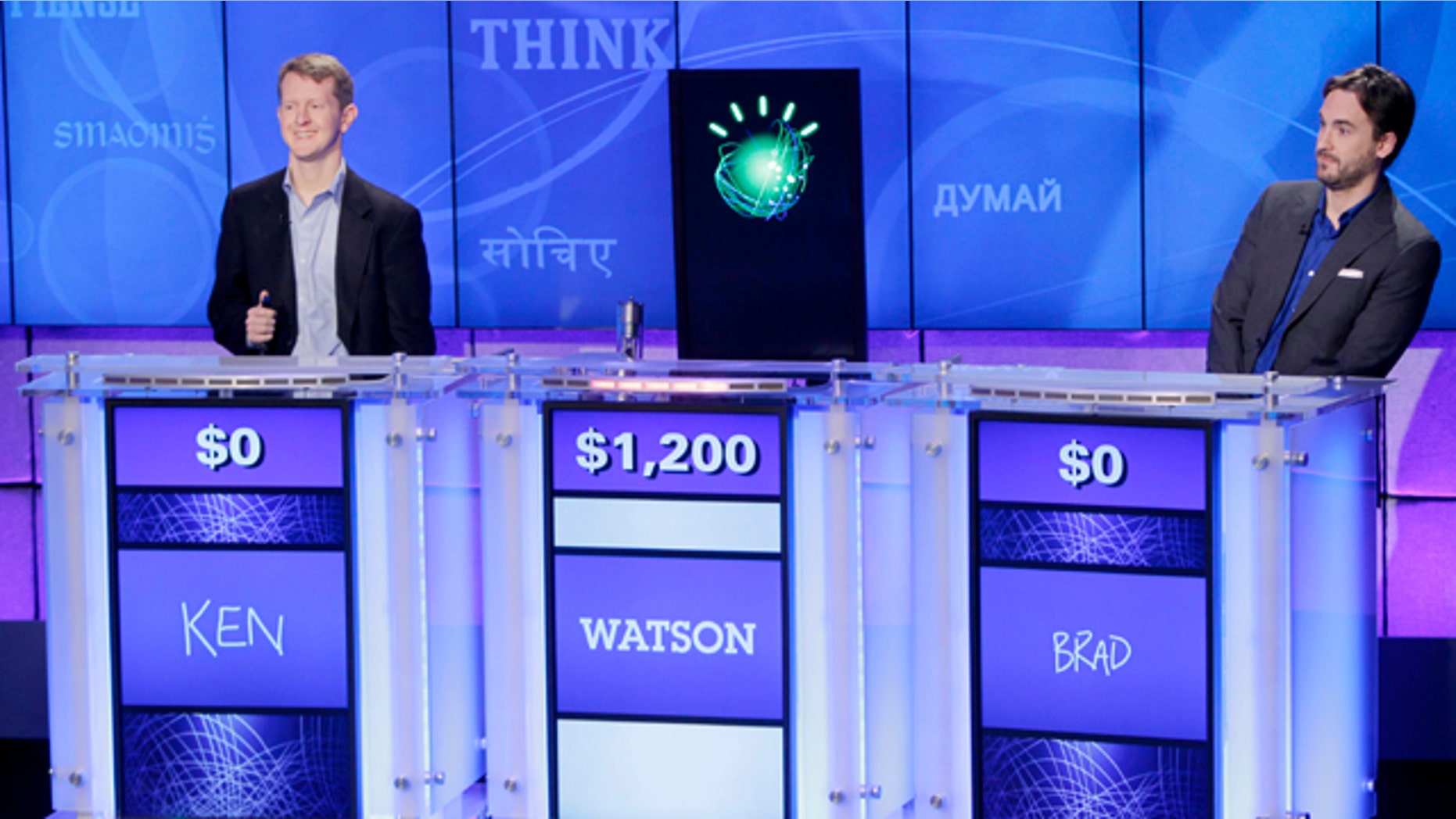 "Jeopardy!" champions Ken Jennings, left, and Brad Rutter, right, look on as an IBM computer called "Watson" beats them to the buzzer to answer a question during a practice round of the "Jeopardy!" quiz show in Yorktown Heights, N.Y., Thursday, Jan. 13, 2011.