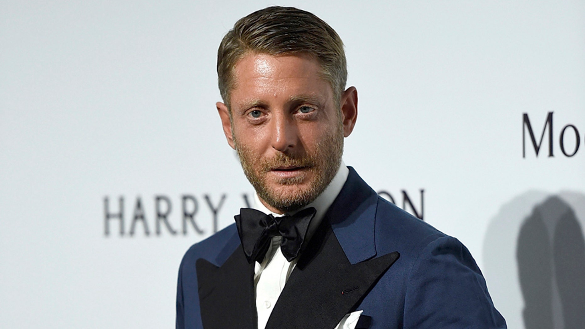 FILE - In this Sept. 26, 2015 file photo, Lapo Elkann arrives for an amfAR charity dinner in Milan, Italy. A criminal charge by the Manhattan district attorney has been dropped against the playboy grandson of the Italian founder of Fiat Automobiles who had been accused of filing a false report when he claimed he was being held against his will in New York City. The 39-year-old was arrested outside a public housing project in December 2016 after his family contacted police, saying he needed $10,000 to guarantee his safety. But authorities say he made up the story after he ran out of money following a two-day binge with an escort. (AP Photo/Giuseppe Aresu, File)