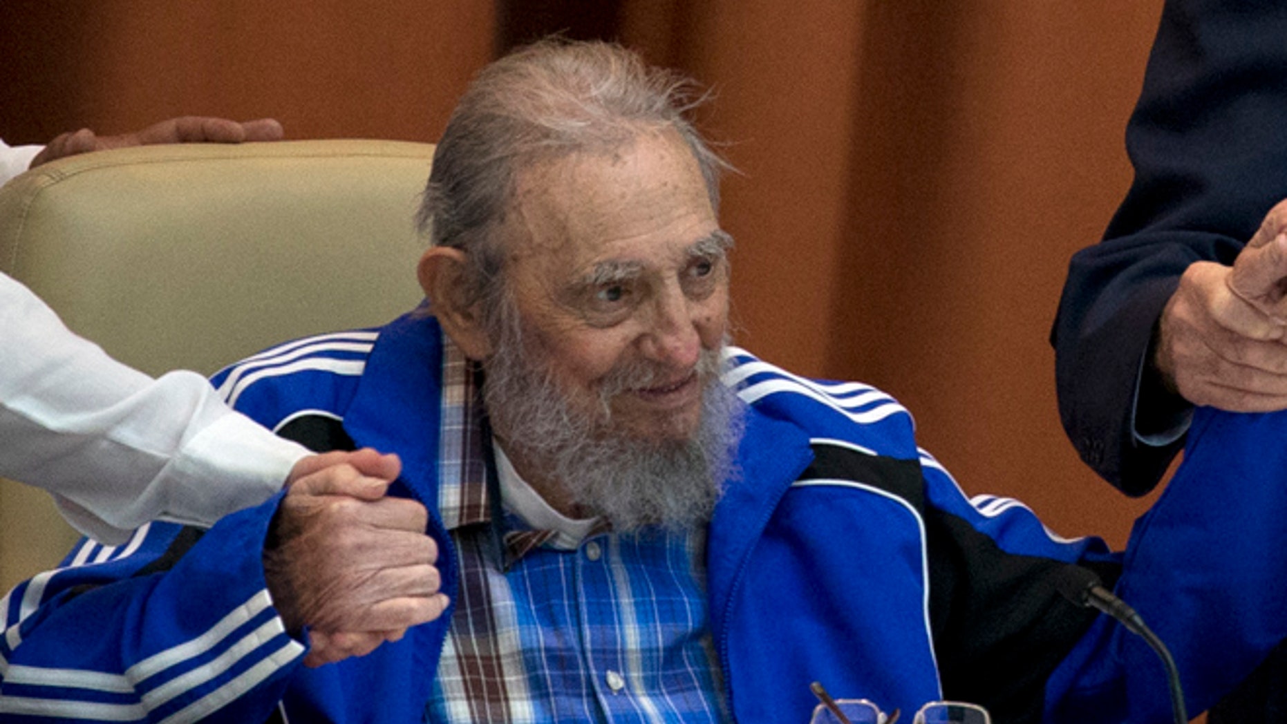April 19: Fidel Castro sits as he clasps hands with his brother, Cuban President Raul Castro, right, and second secretary of the Central Committee, Jose Ramon Machado in Havana.