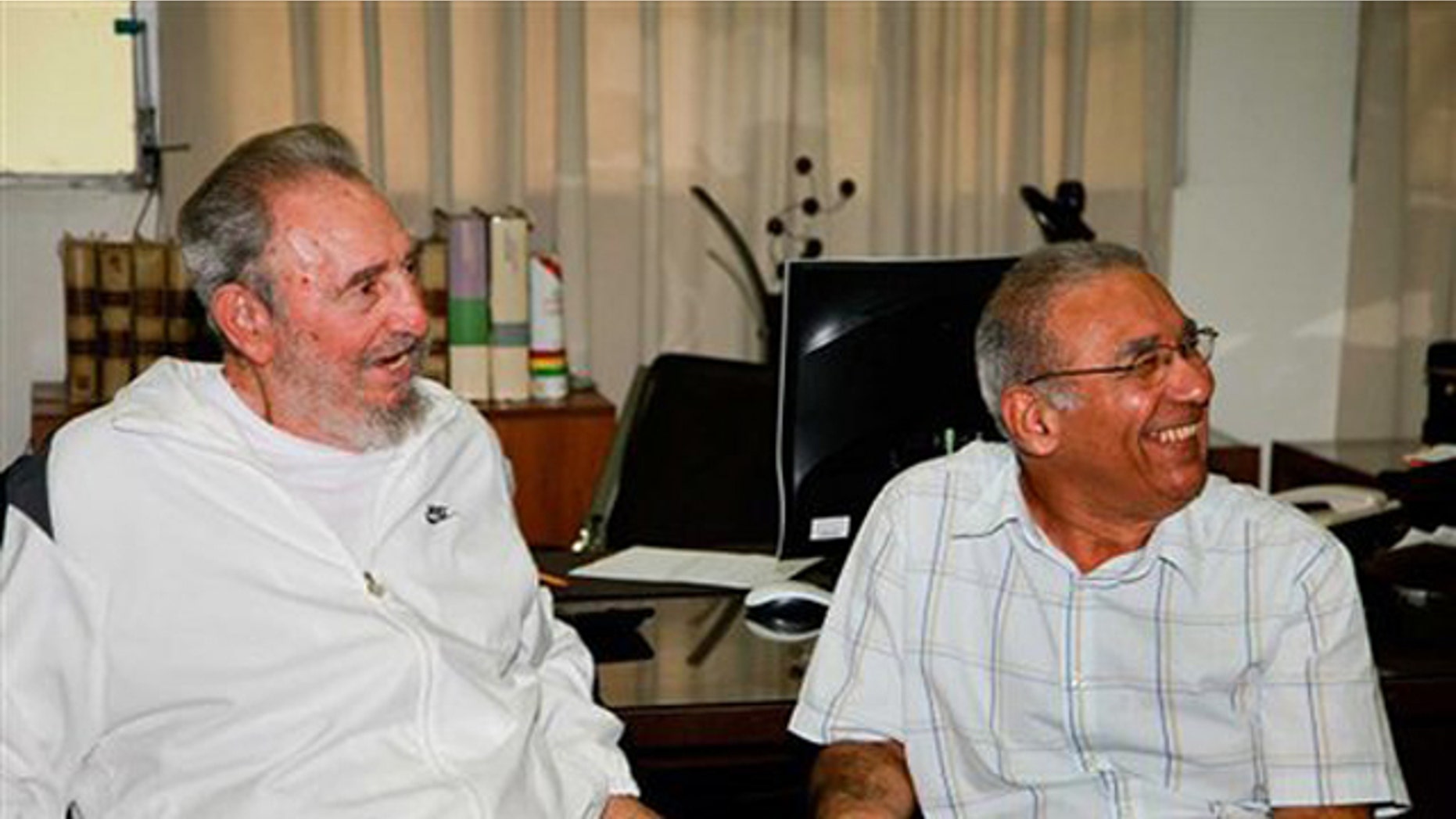 In this image released on Saturday July 10, 2010 by the state media Cubadebate website, Cuban leader Fidel Castro sits next to an unidentified man during a visit to the National Center for Scientific Investigation in Havana last July 7, 2010.