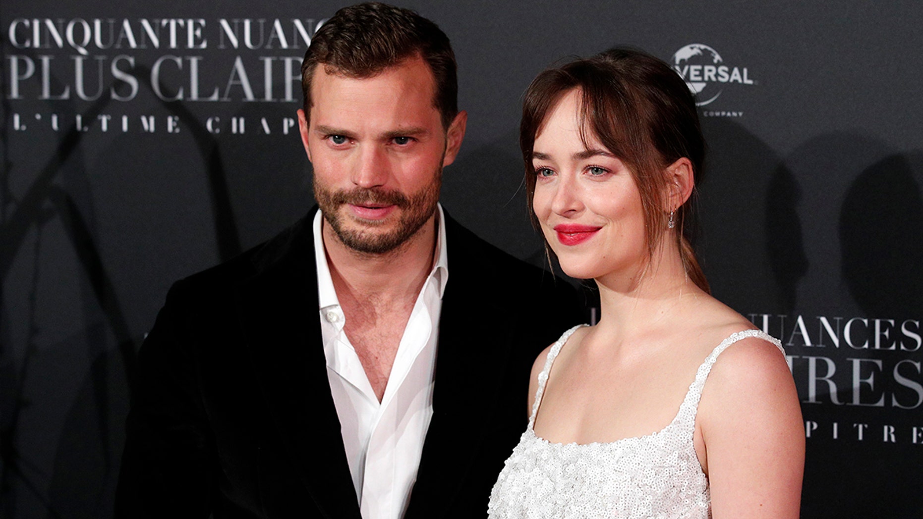 Jamie Dornan, left, and Dakota Johnson pose during a photocall for the world premiere of 'Fifty Shades Freed - 50 Nuances Plus Claires' at Salle Pleyel in Paris, Tuesday, Feb. 6, 2018. (AP Photo/Francois Mori)
