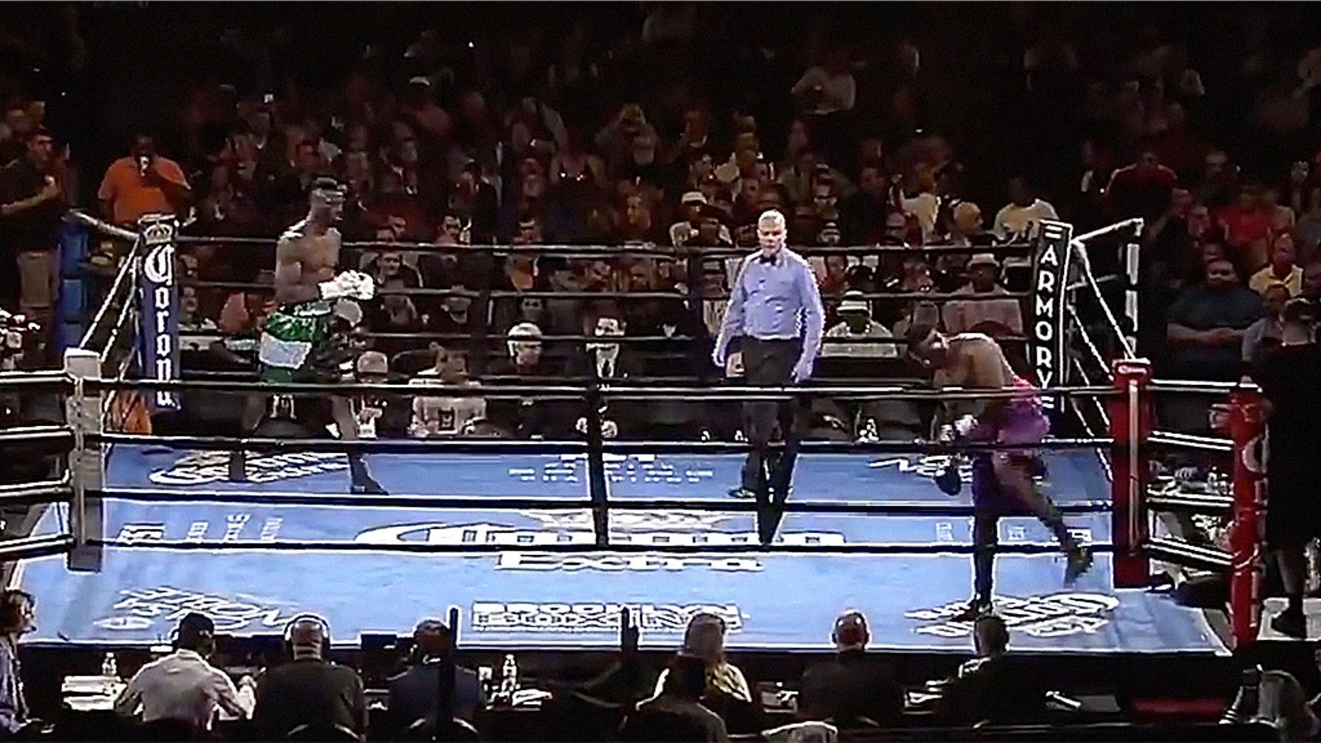 Curtis Harper, bottom right, walks out of the ring, seconds after touching gloves with Efe Ajagba.