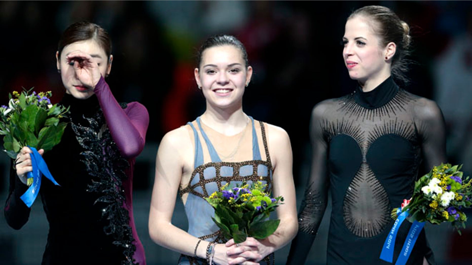 Feb. 20, 2014: Adelina Sotnikova of Russia, centre, Yuna Kim of South Korea, left, and Carolina Kostner of Italy stand on the podium during the flower ceremony for the women's free skate figure skating final at the Iceberg Skating Palace during the 2014 Winter Olympics in Sochi, Russia. Sotnikova placed first, followed by Kim and Kostner.