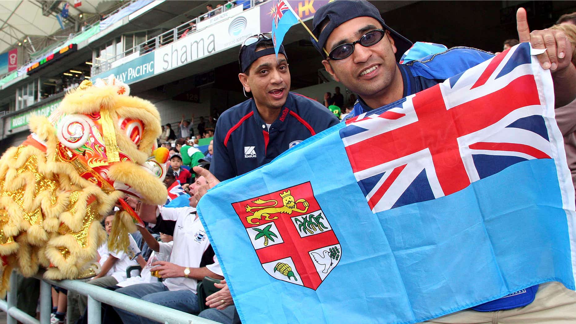 March 18, 2005: Rugby fans hold a Fiji national flag during the Rugby World Cup Sevens in Hong Kong.