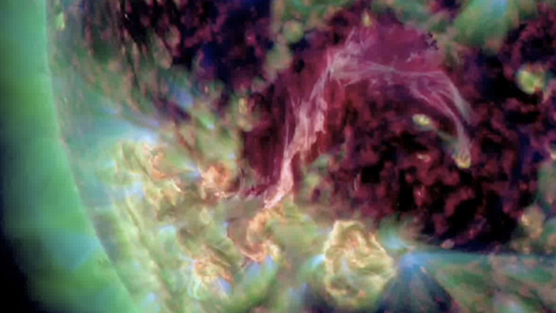 A pinkish-purple filament of hot plasma connects two sunspots in this ultraviolet view recorded by NASA's Solar Dynamics Observatory spacecraft on Aug. 4, 2012.