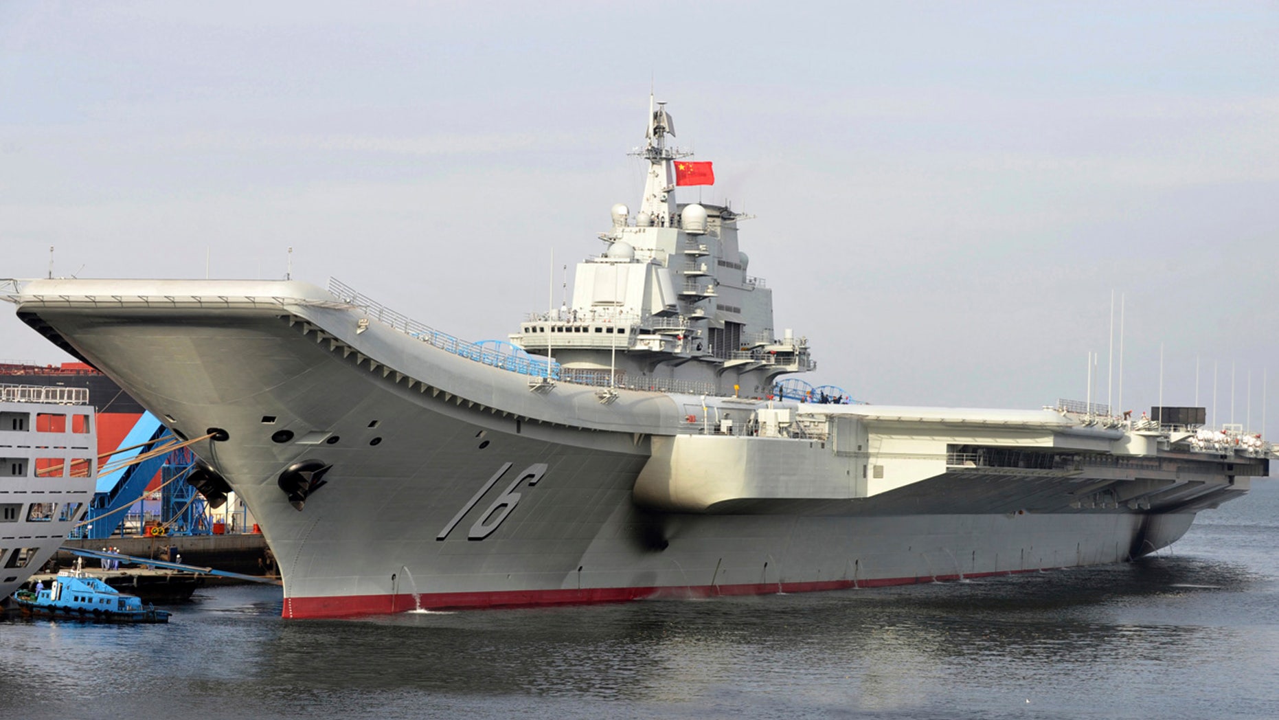 FILE - In this undated file photo released by China's Xinhua News Agency, China's aircraft carrier Liaoning berths in a port of China.