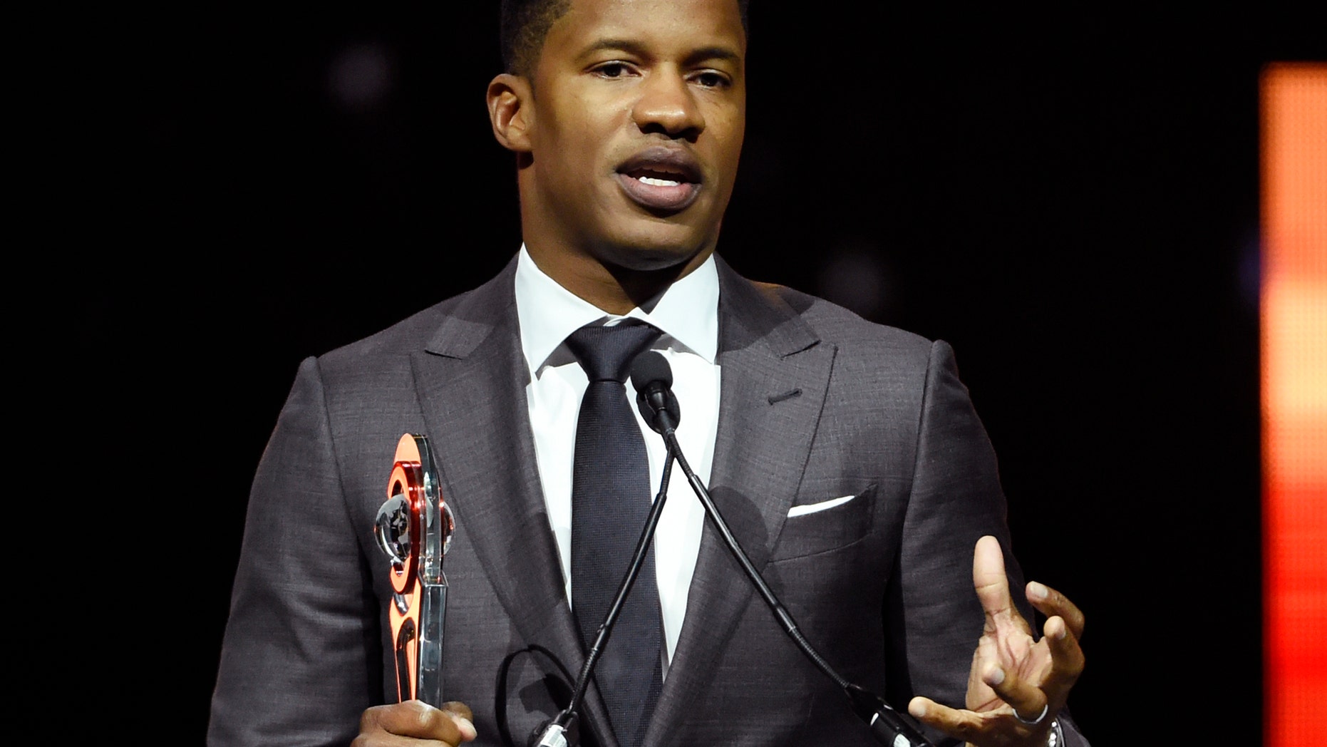FILE - In this April 14, 2016 file photo, Nate Parker, director of the upcoming film "The Birth of a Nation," accepts the Breakthrough Director of the Year award during the CinemaCon 2016 Big Screen Achievement Awards in Las Vegas. The American Film Institute has canceled plans to screen writer-director Nate Parkerâs âThe Birth of a Nationâ for students this week amid controversies surrounding a 17 year old rape accusation of Parker and his co-writer. (Photo by Chris Pizzello/Invision/AP, File)