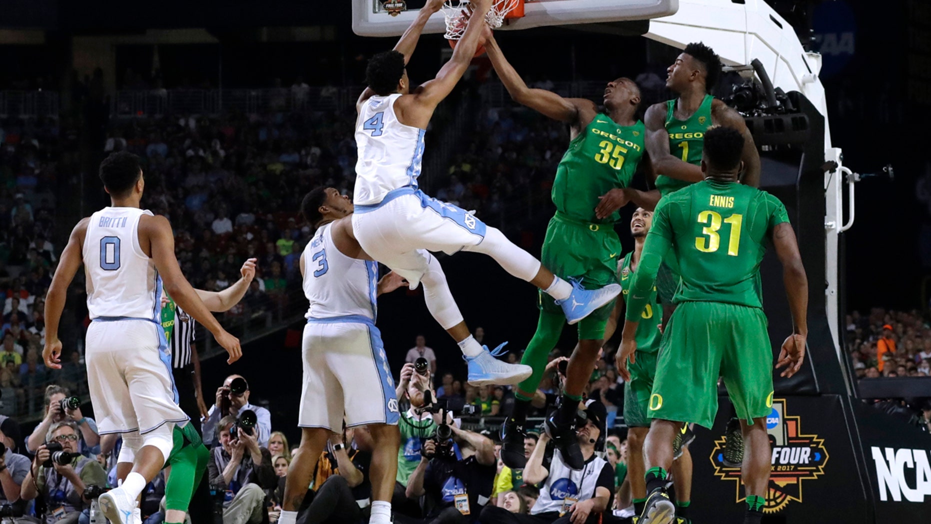 North Carolina forward Isaiah Hicks (4) dunks the ball over Oregon's Kavell Bigby-Williams (35) and Jordan Bell (1) during the first half in the semifinals of the Final Four NCAA college basketball tournament, Saturday, April 1, 2017, in Glendale, Ariz. (AP Photo/David J. Phillip)