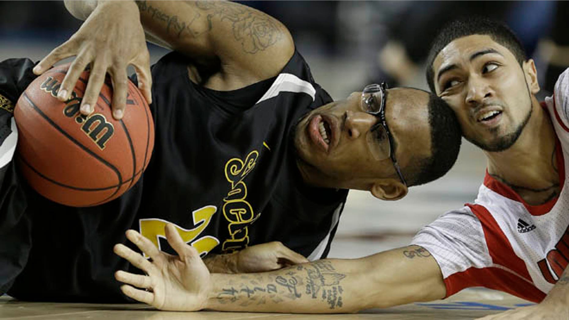 April 6, 2013: Wichita State's Carl Hall (22) and Louisville's Russ Smith (2) vie for a loose ball during the second half of the NCAA Final Four tournament college basketball semifinal game in Atlanta.