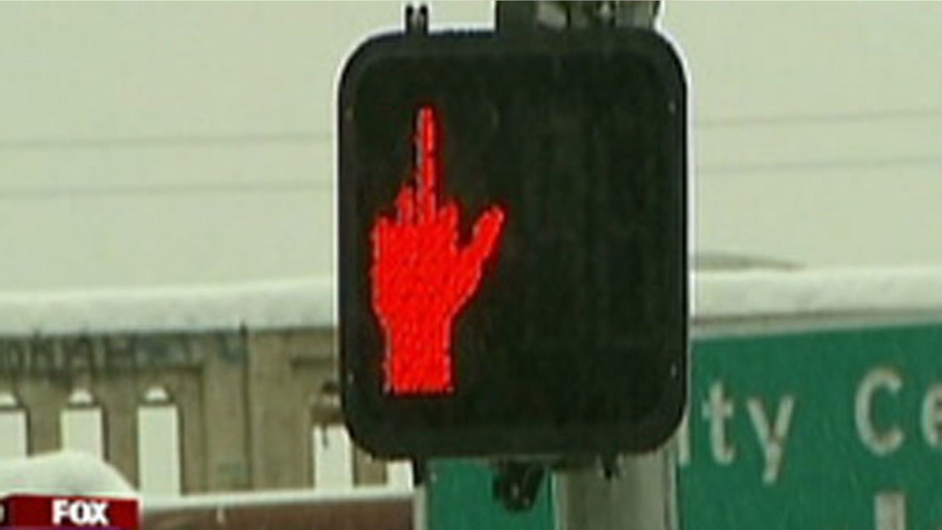 A crosswalk sign in Spokane, Washington was obscured on December 2, 2010 and appeared to be giving pedestrians the middle finger.