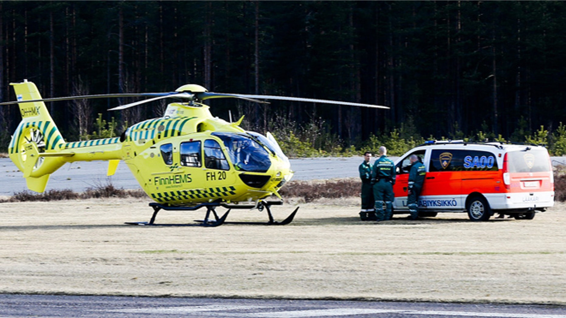 April 20, 2014: A helicopter and an ambulance are seen at the Jamijarvi Airfield, southwest Finland. A small passenger plane carrying parachuters fell to the ground near the airfield on Sunday afternoon. The police say that there are more than three victims. Three people out of 11 on the plane were rescued.