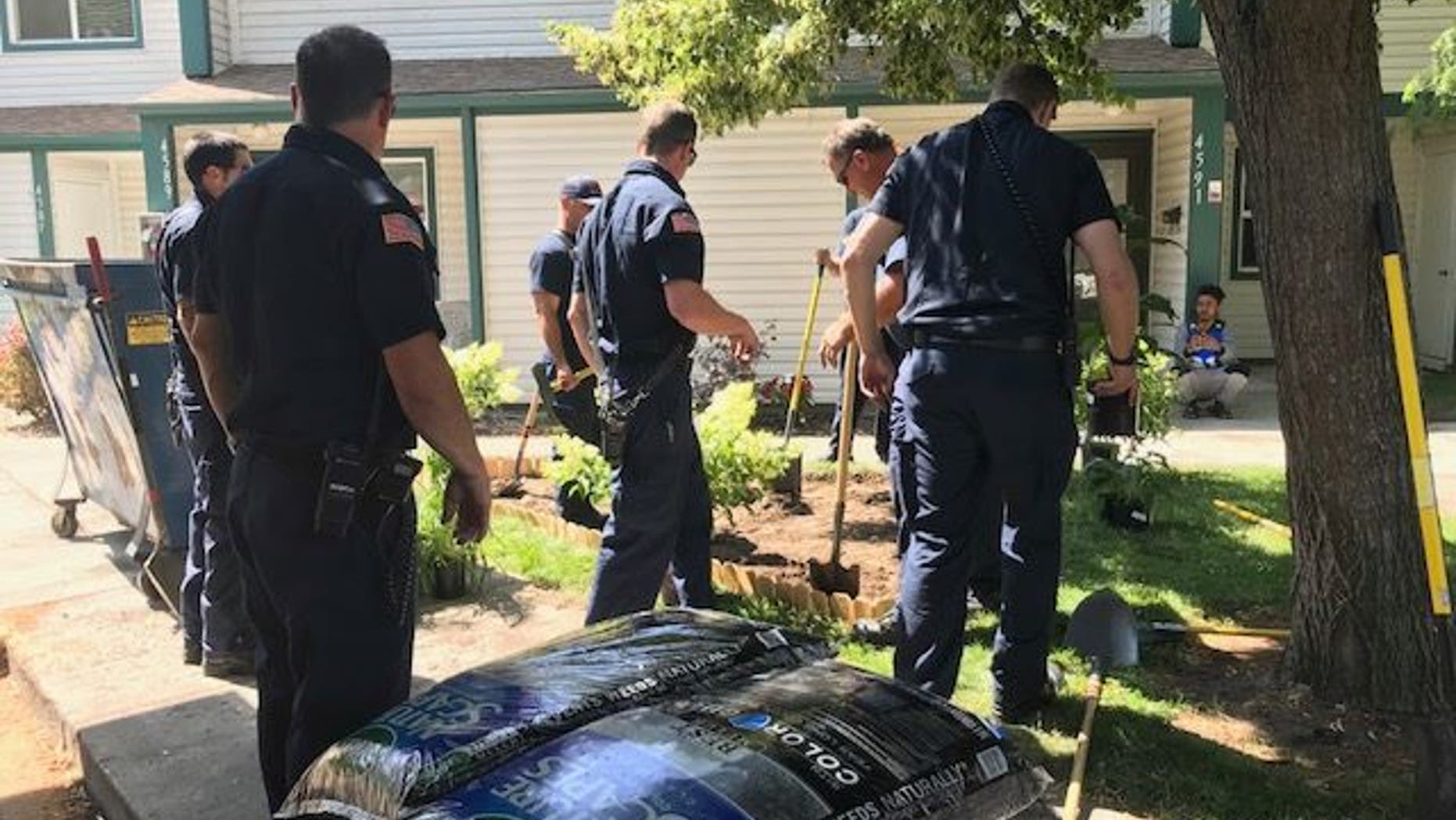 Firefighters with the Boise Fire Department work to build the memorial garden.