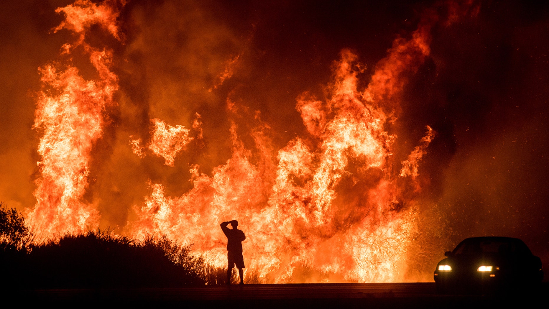Wildfires continued to spread Friday across Southern California, with local officials confirming the first fatality.