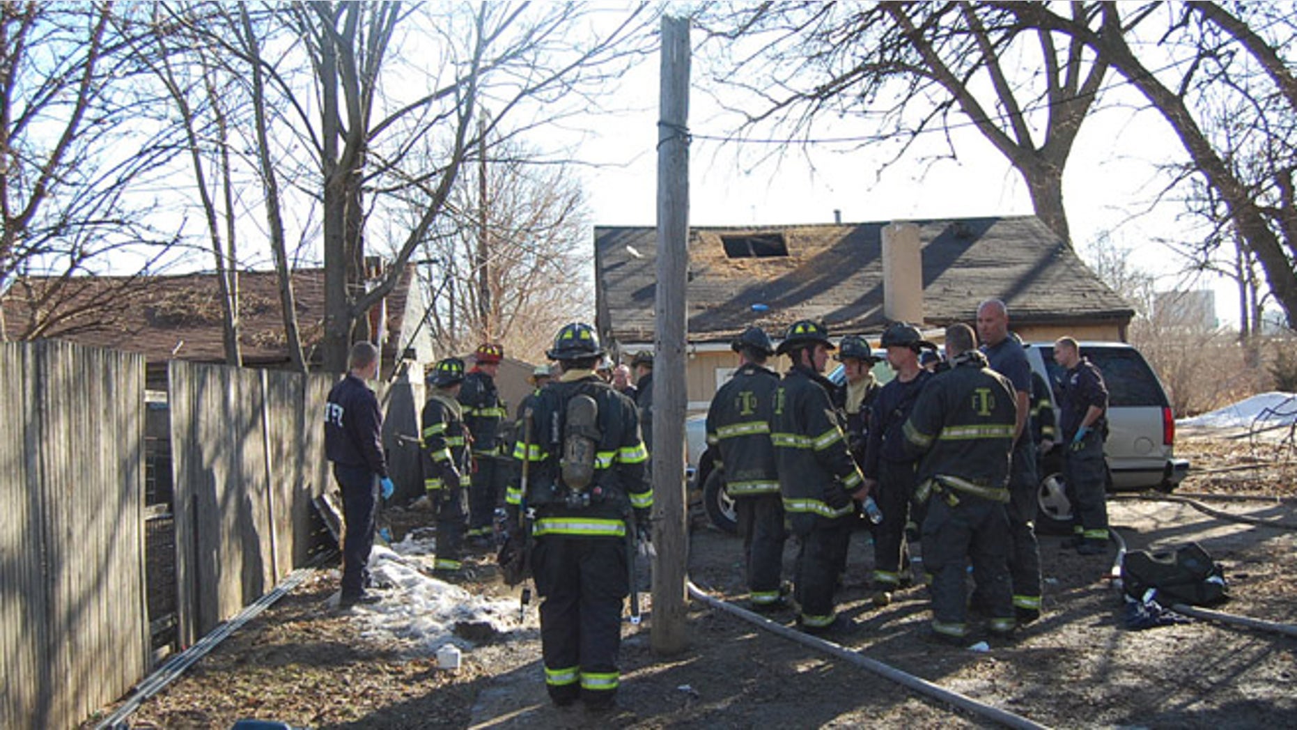 Feb. 22, 2014: This photo provided by the Indianapolis Fire Department, fire and emergency personnel look over the scene of a fire in Indianapolis.