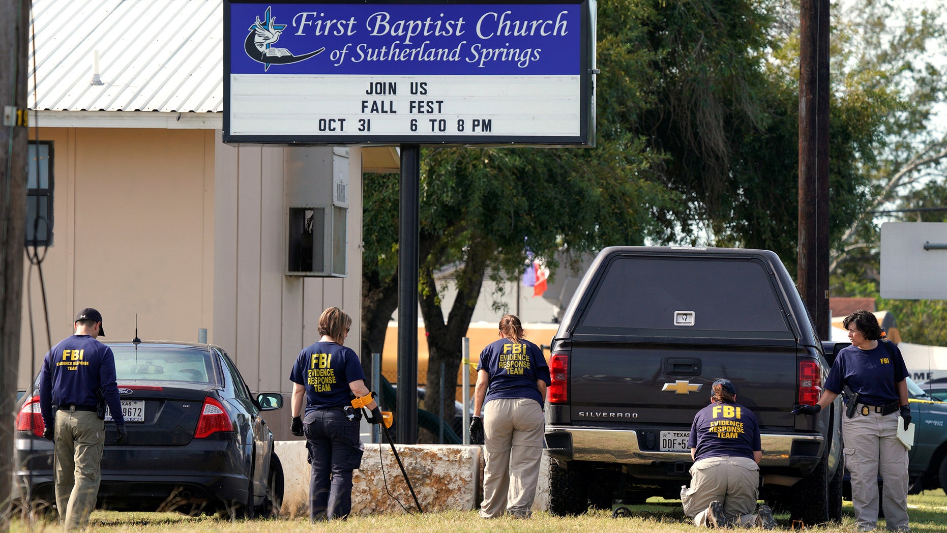 Members of the FBI Evidence Response Team use metal detectors outside the site of the shooting at the First Baptist Church of Sutherland, Texas, U.S., November 6, 2017. REUTERS/Rick Wilking - RC15DC1B1320