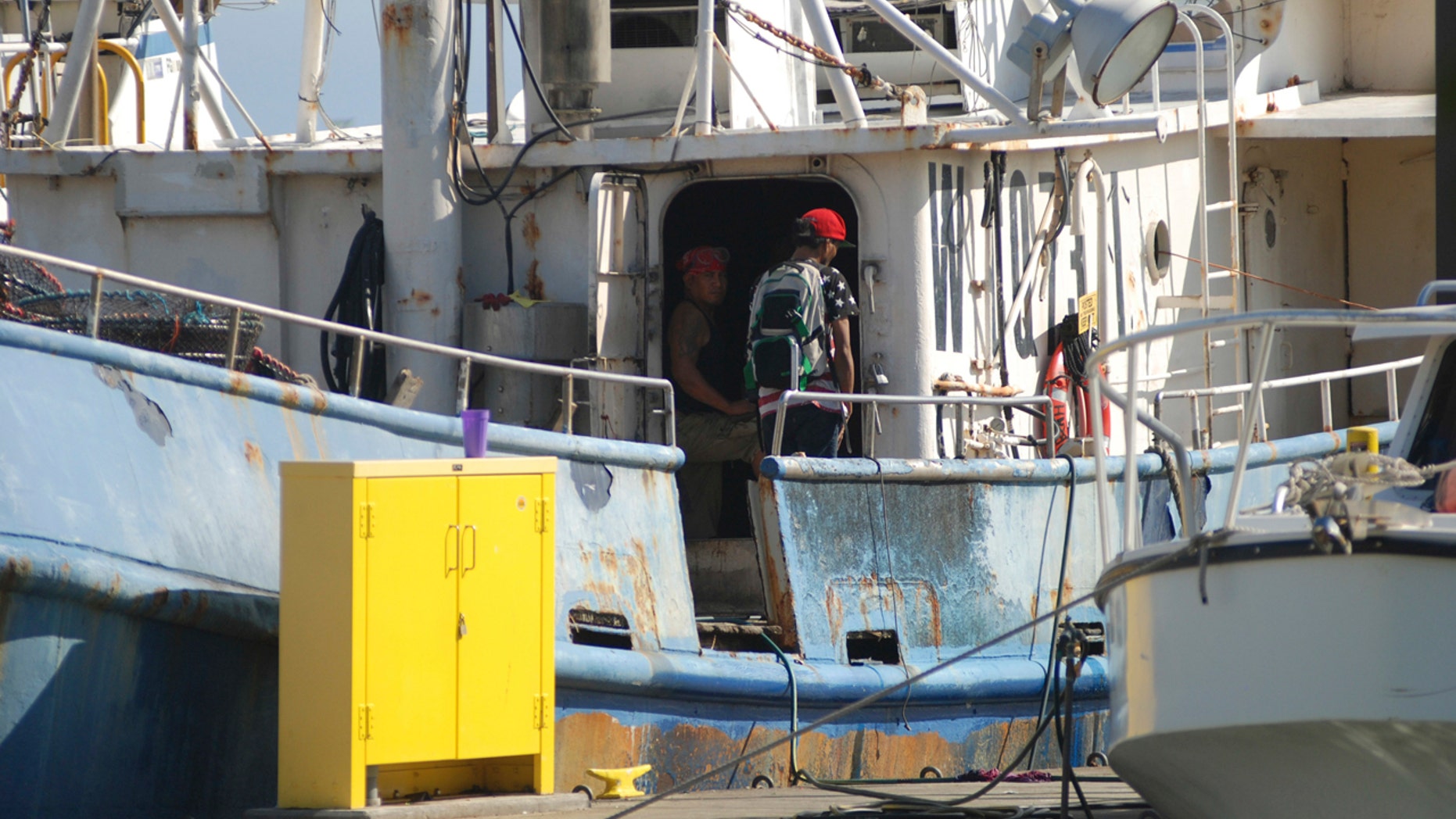 In this Sept. 14, 2016 file photo, fishermen stand on a boat at Pier 38 in Honolulu. A group of Hawaii lawmakers is holding a public meeting to discuss conditions among the Hawaii longline fleet.