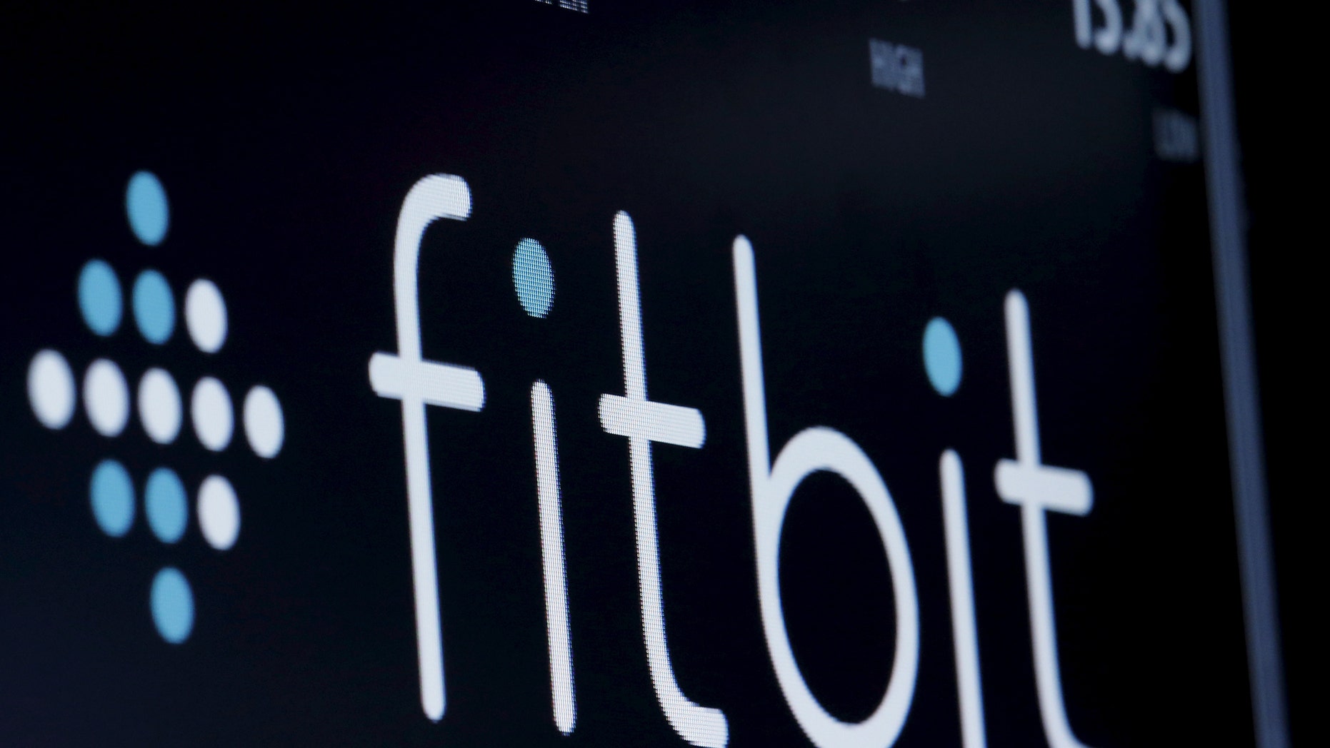 File photo: The ticker symbol for Fitbit is displayed at the post where it is traded on the floor of the New York Stock Exchange (NYSE) February 23, 2016. (REUTERS/Brendan McDermid)