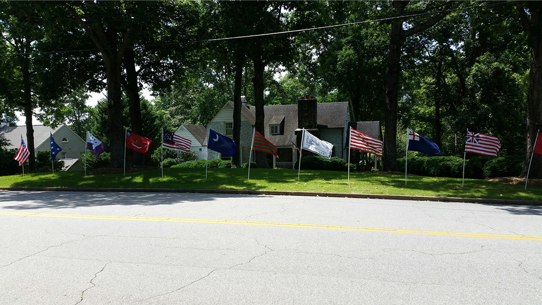 Revolutionary War-era flags stand in Eric Monday's front yard in Martinsville, Va.