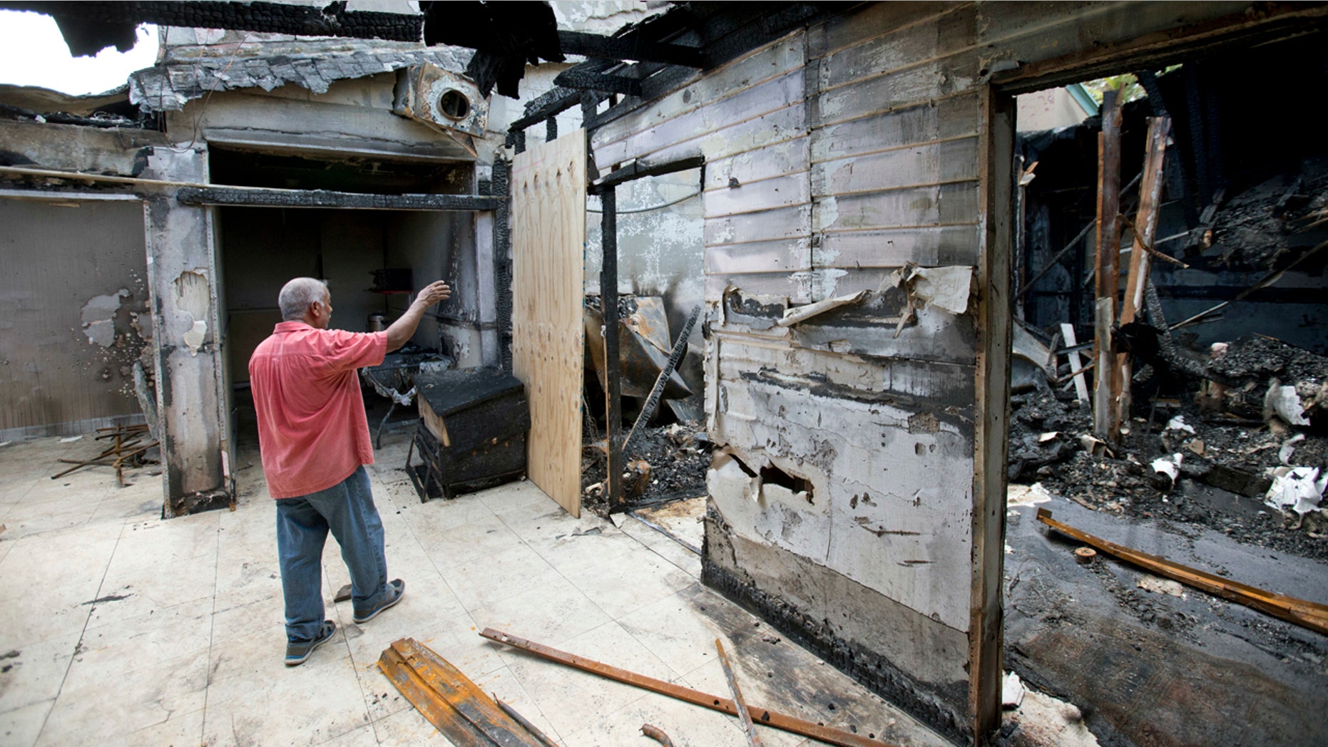 Sept. 15, 2016: Farhad Khan, who has attended the Islamic Center of Fort Pierce for more than seven years, shows members of the media its charred remains, in Fort Pierce, Fla.