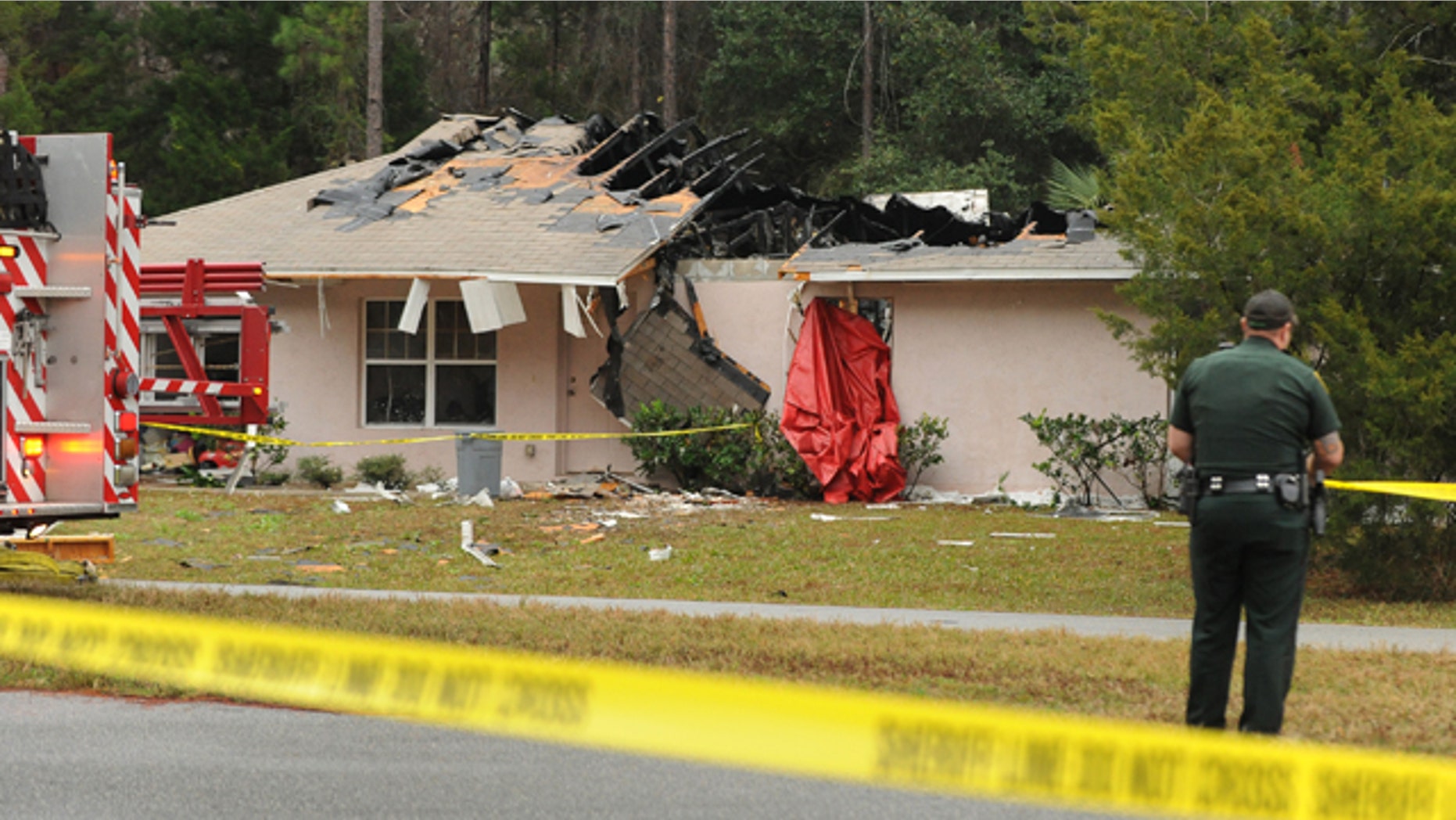 Jan. 4, 2013: Emergency personnel investigate the scene of a plane crash in Palm Coast, Fla.