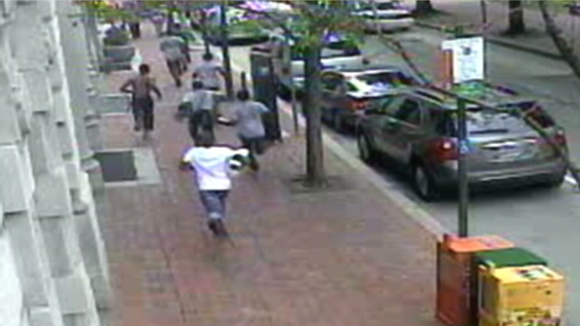 This security image, obtained by Fox affiliate WTXF-TV, shows a group of teens running from an alleged "flash mob" attack in Philadelphia's Old City section on July 29. Three juveniles have so far been arrested in connection to the assault on an innocent bystander, police said.