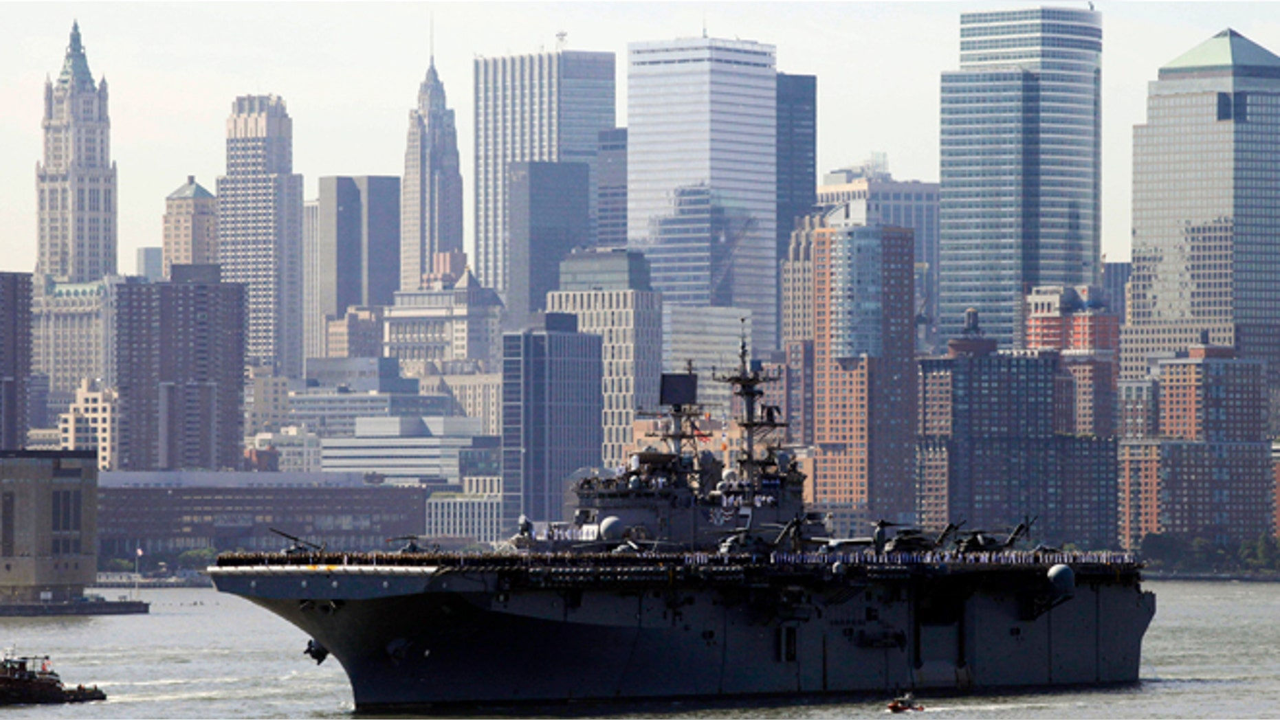 May 26, 2010: Sailors line the deck of the USS Iwo Jima as it passes the lower Manhattan skyline on arrival in New York Harbor for the start of Fleet Week. After a year's absence, Fleet Week is coming back to New York City. Three Navy ships and two Coast Guard cutters are scheduled to arrive in New York Harbor on Wednesday, May 21, 2014, the start of the week. (AP/Mark Lennihan, File)