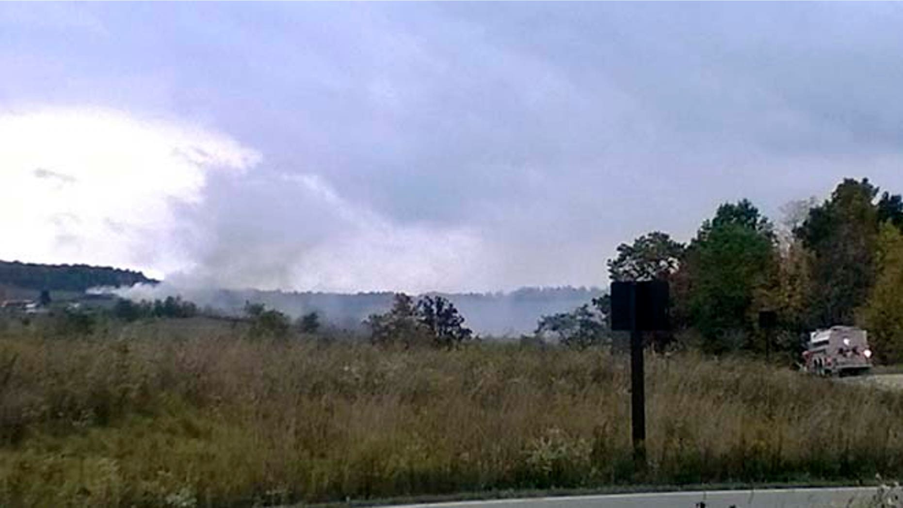 Oct. 3, 2014: Smoke rises in the background as firefighters respond to a fire at the Flight 93 National Memorial Friday, Oct. 3, 2014, in Shanksville, Pa.