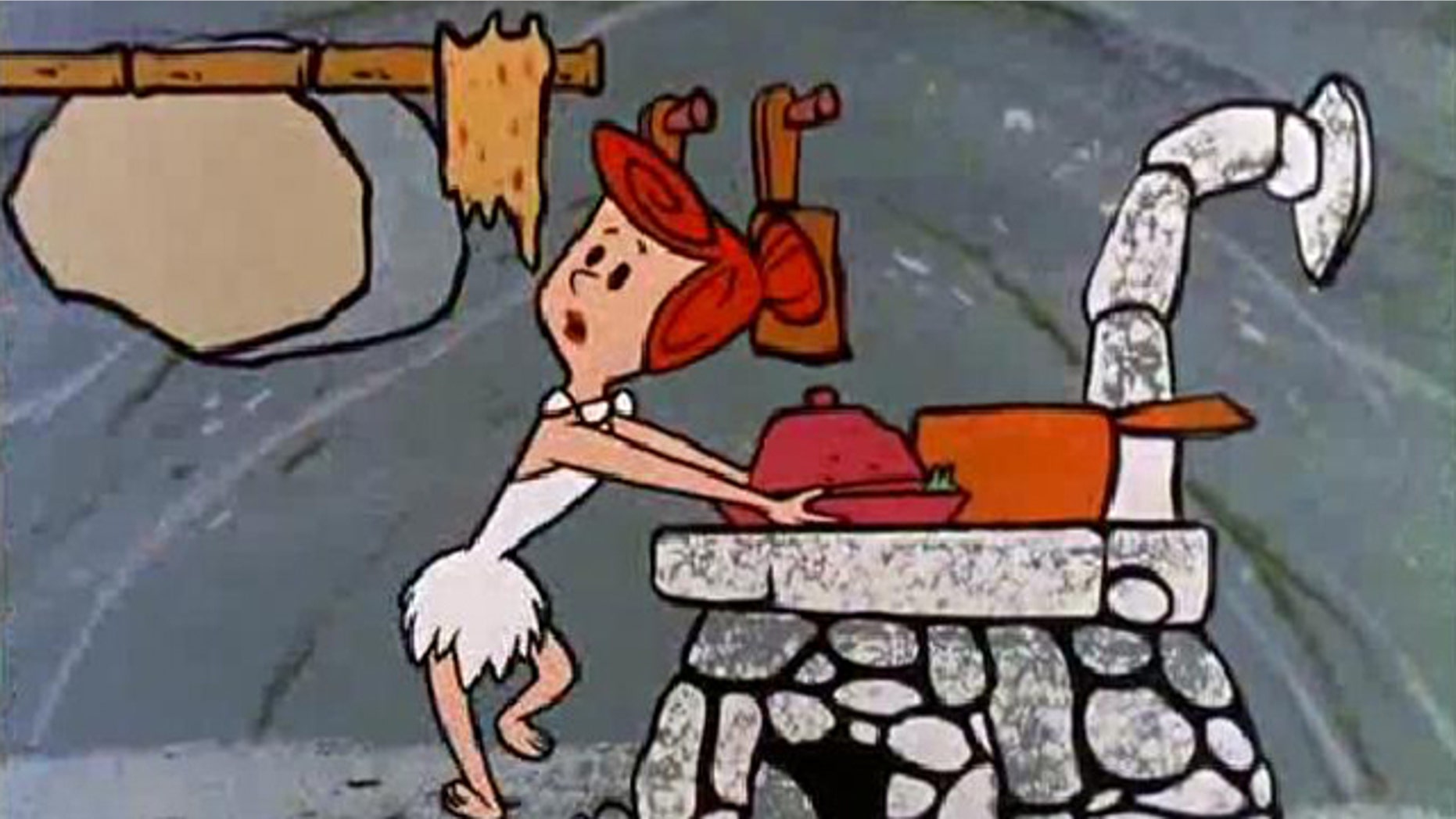 Wilma pulls dinner off the stove for a hungry Fred Flintstone. New archaeological discoveries indicate that the living facility seen in the cartoon was actually fairly accurate.