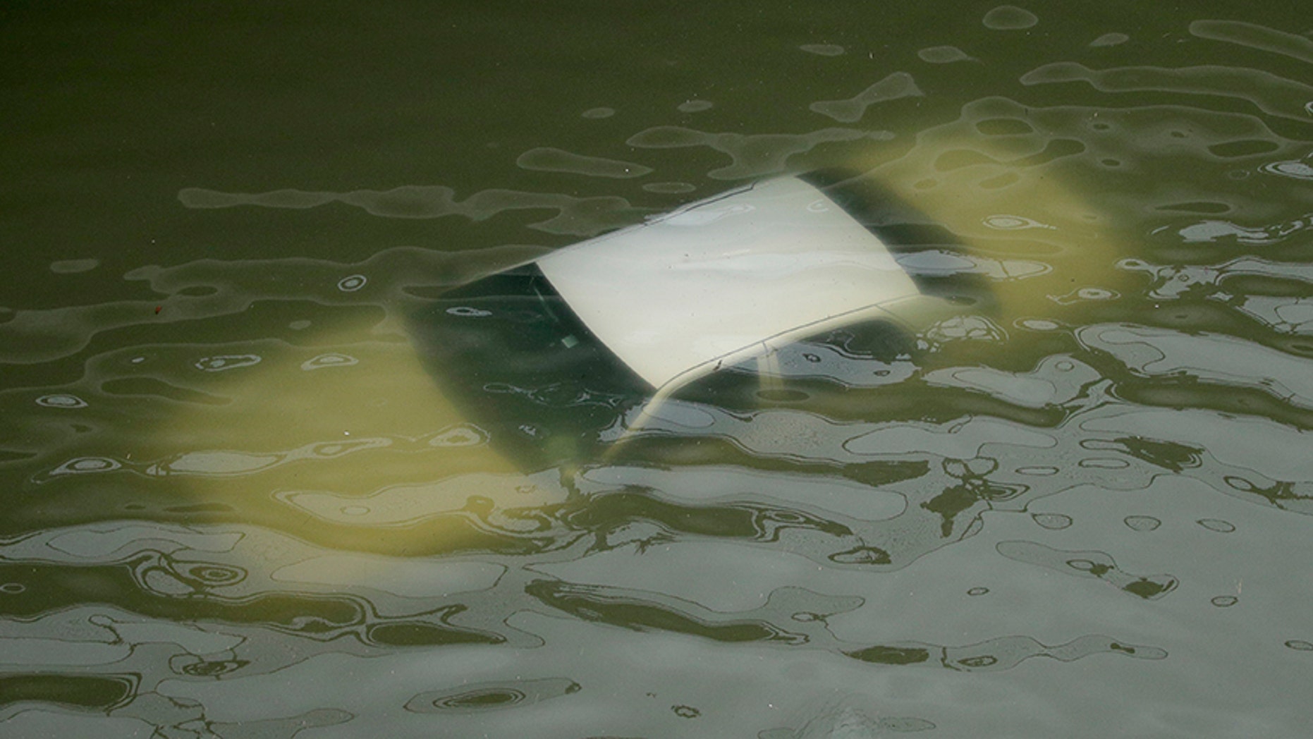 A car is submerged on a freeway flooded by Tropical Storm Harvey on Sunday, Aug. 27, 2017, near downtown Houston, Texas. The remnants of Hurricane Harvey sent devastating floods pouring into Houston on Sunday as rising water chased thousands of people to rooftops or higher ground. (AP Photo/Charlie Riedel)