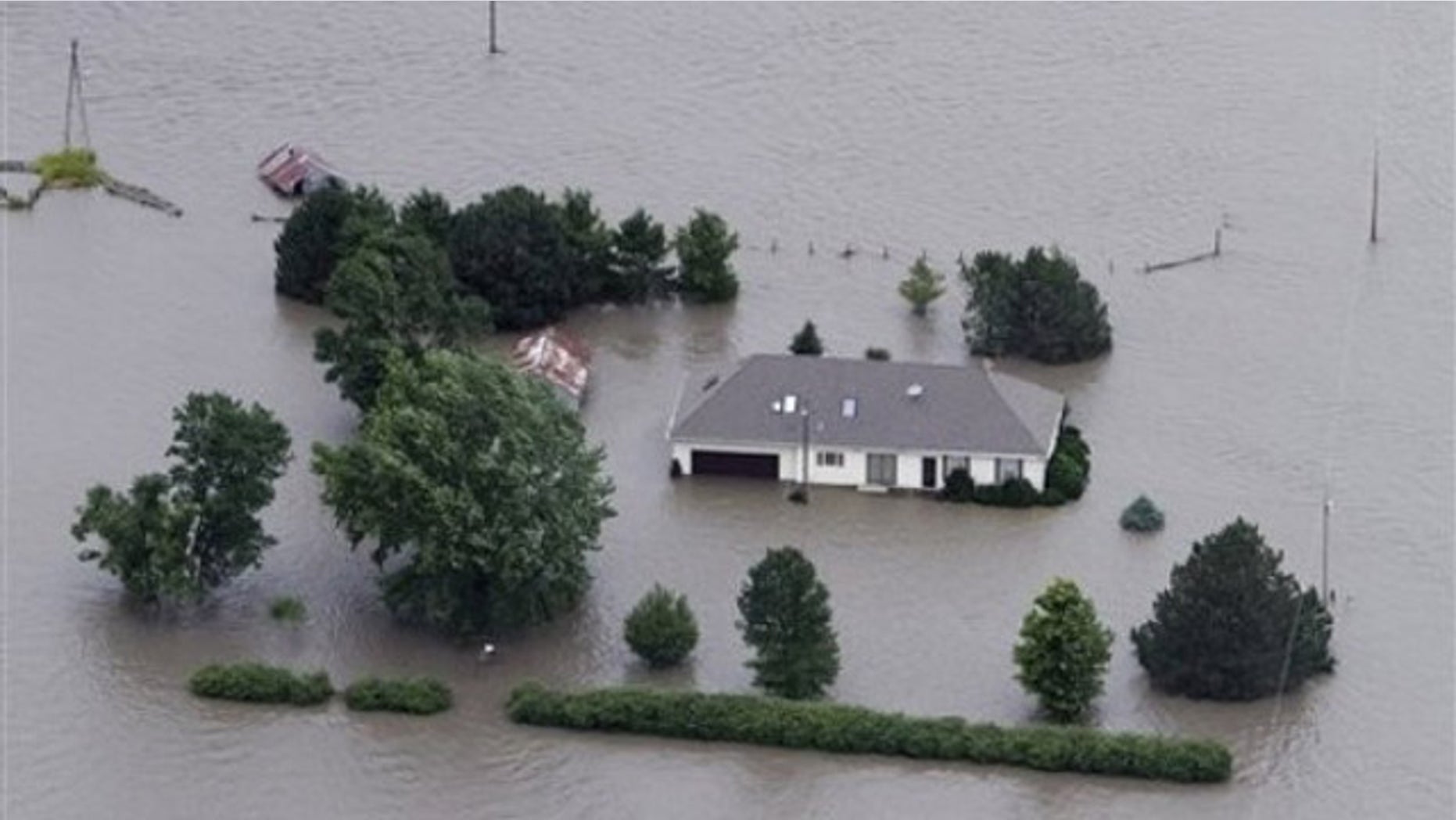 June 13: A home is engulfed by flood water in Hamburg, Iowa. The rising Missouri River has ruptured two levees in northwest Missouri, sending torrents of floodwaters over rural farmland toward the Iowa town of Hamburg and the Missouri resort town of Big Lake.