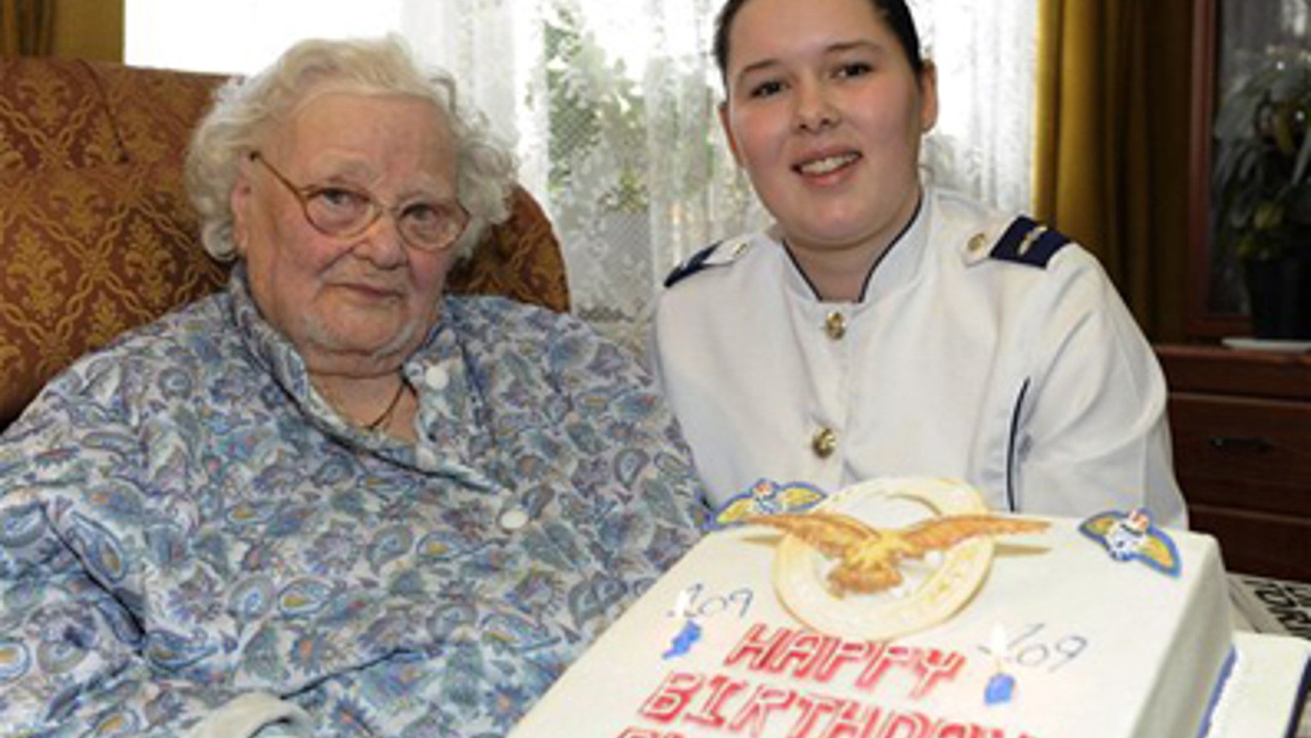 In this Feb. 19, 2010 photo released by the British Ministry of Defense, MOD, shows Florence Green, left, on her 109th birthday being presented with a birthday cake by LAC Hannah Shaw on behalf of the RAF at her home in King's Lynn, east England. Florence Green, the world's last known veteran of World War I, has died at the age of 110, the care home where she lived said Tuesday.