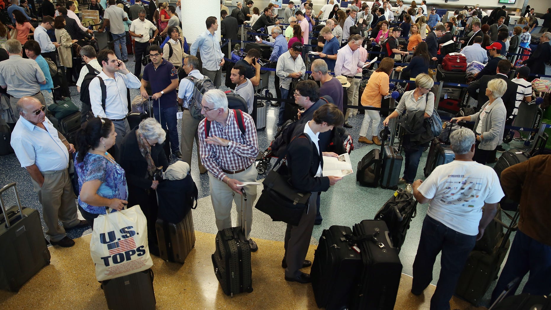Passengers wait in line at Miami International Airport on April 16, 2013 in Miami, Florida. (Photo by Joe Raedle/Getty Images)