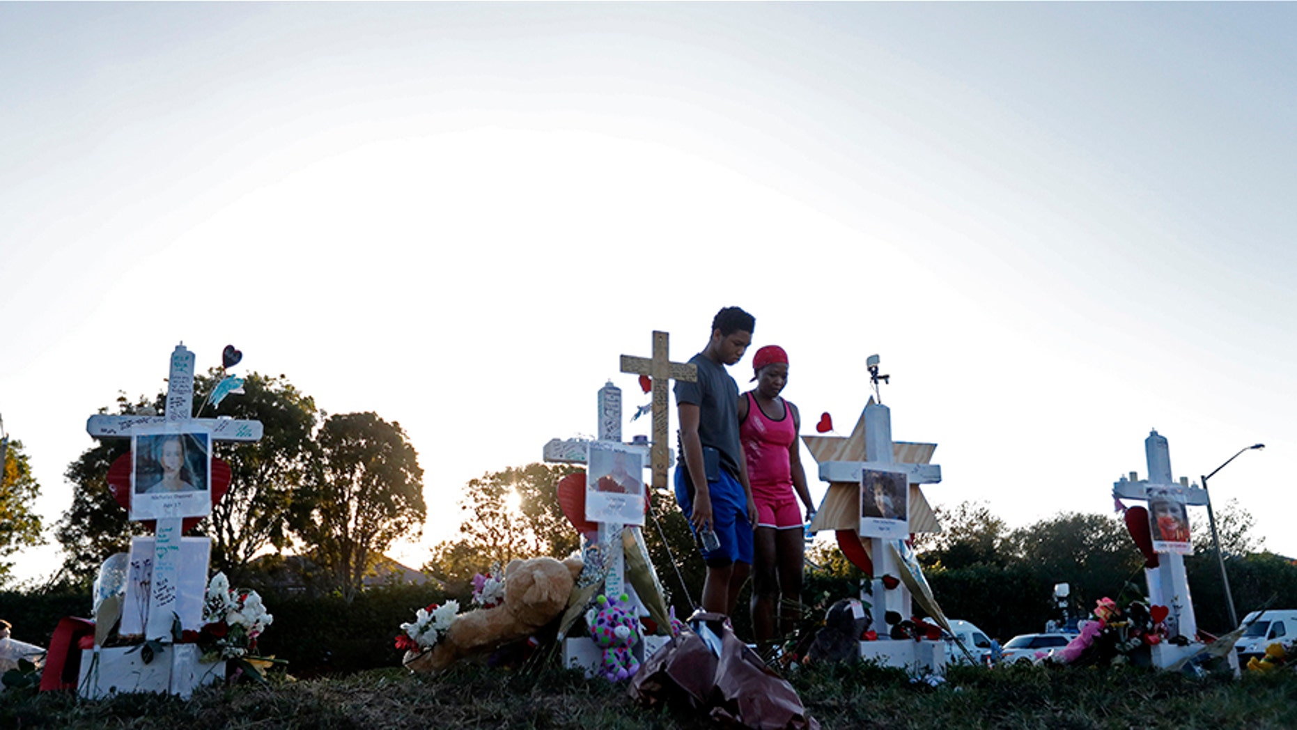 People visiting a makeshift memorial outside Marjory Stoneman Douglas High School, where 17 people were killed on Feb. 14.