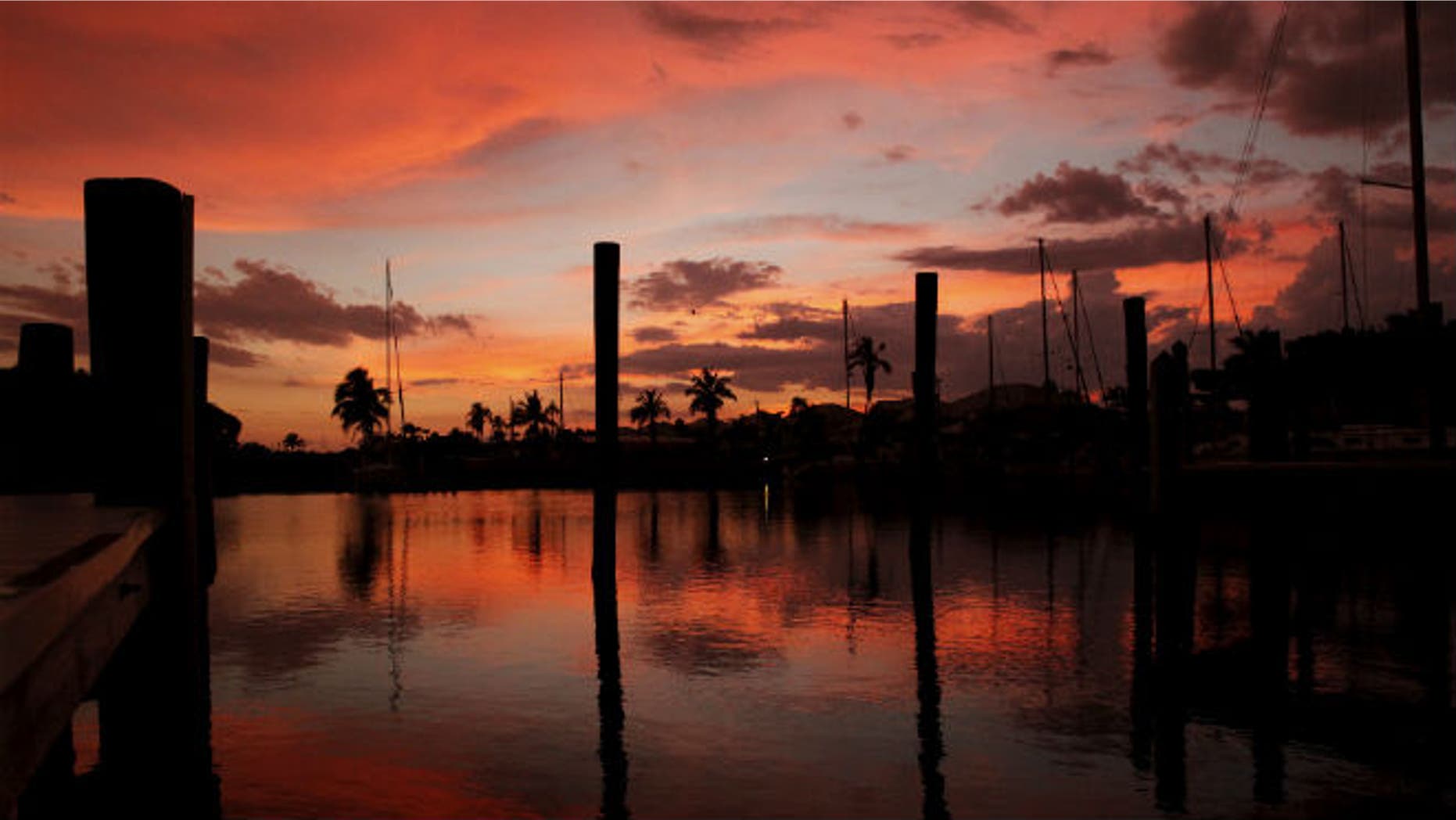 The sun sets over a marina in Fort Myers Beach, Florida June 20, 2015. REUTERS/Jim Bourg