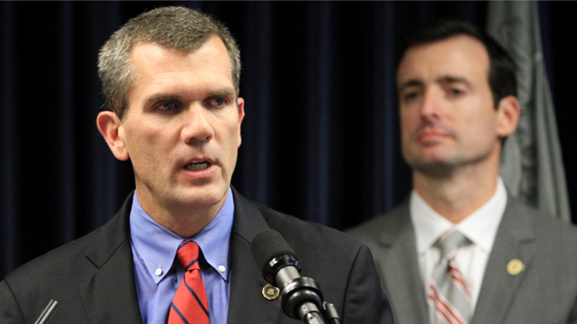 May 3, 2012: John V. Gillies, Special Agent in Charge, Federal Bureau of Investigation, Miami Field Office, left, answers a question to a reporters as Wifredo Ferrer, U.S. Attorney for the Southern District of Florida, looks on, in Miami.