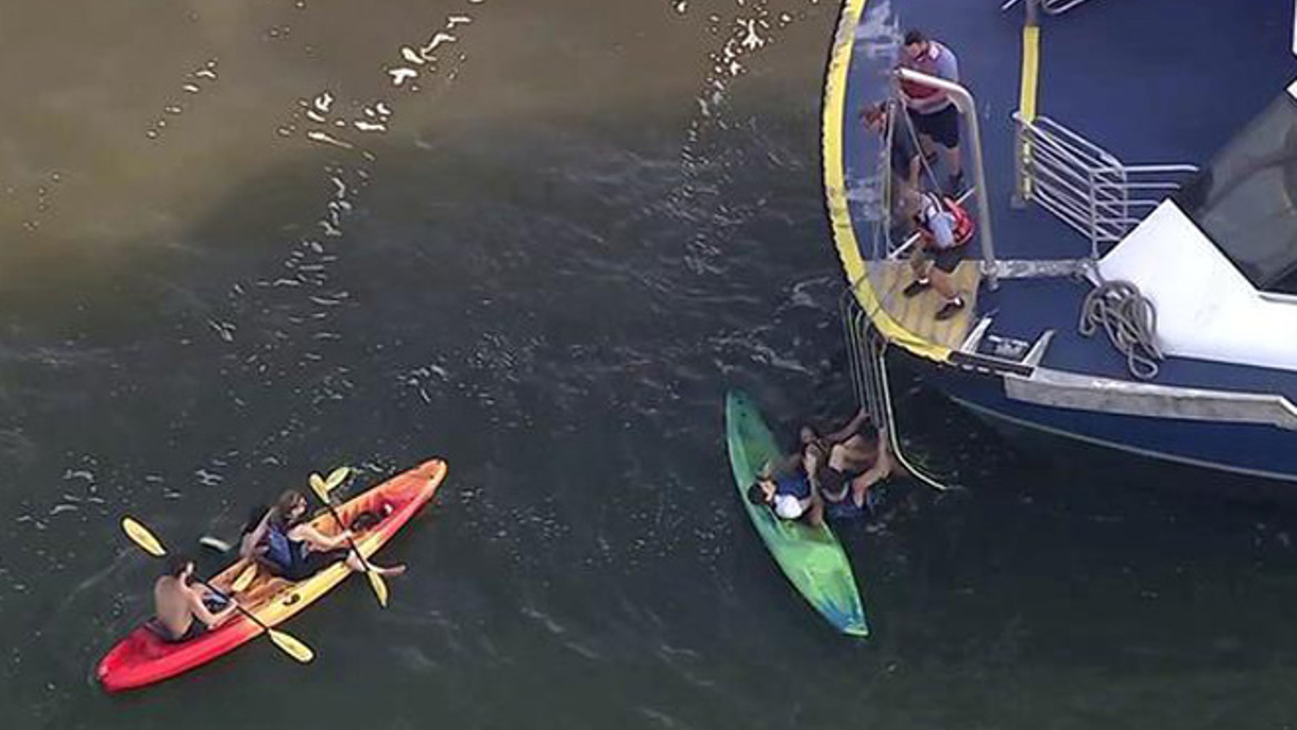 This image made from a video provided by WABC-TV shows kayakers being rescued on the Hudson River, Tuesday, Aug. 30, 2016, on the west side of Manhattan. (WABC-TV via AP)