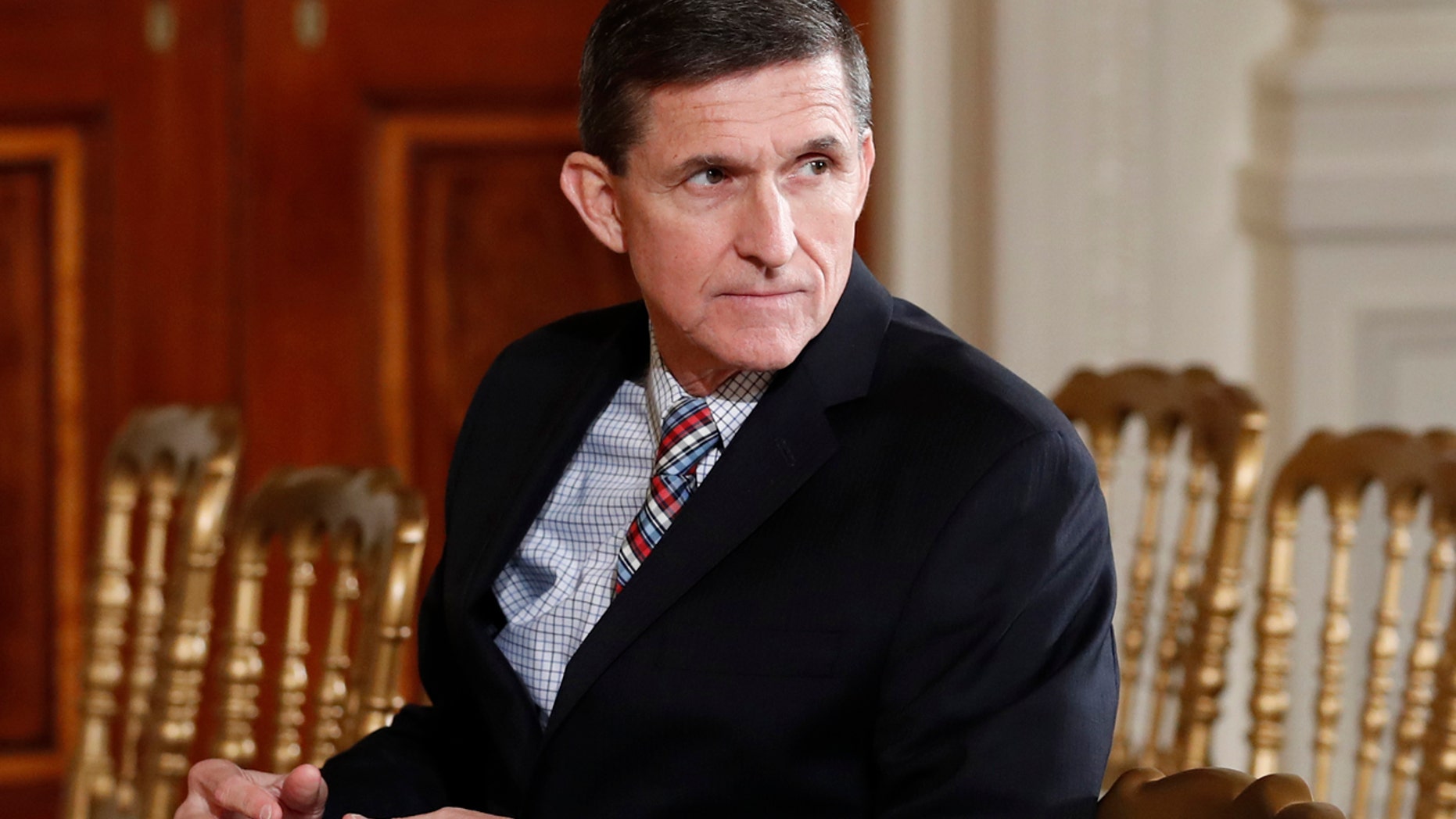 FILE - In this Feb. 10, 2017 file photo, then-National Security Adviser Michael Flynn sits in the East Room of the White House in Washington. A member of Donald Trump's transition team asked national security officials in the Obama White House for the classified CIA profile on Russia's ambassador to the United States. The unusual request appears to signal that Trump's own team had concerns about whether his pick for national security adviser, Mike Flynn, fully understood that he was dealing with a man rumored to have ties to Russian intelligence agencies. (AP Photo/Carolyn Kaster, File)