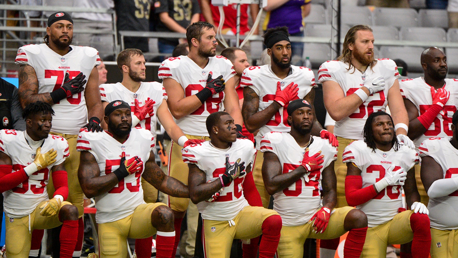 Oct 1, 2017; Glendale, AZ, USA; Members of the San Francisco 49ers kneel during the National Anthem prior to a game against the Arizona Cardinals at University of Phoenix Stadium. Mandatory Credit: Matt Kartozian-USA TODAY Sports - 10321248