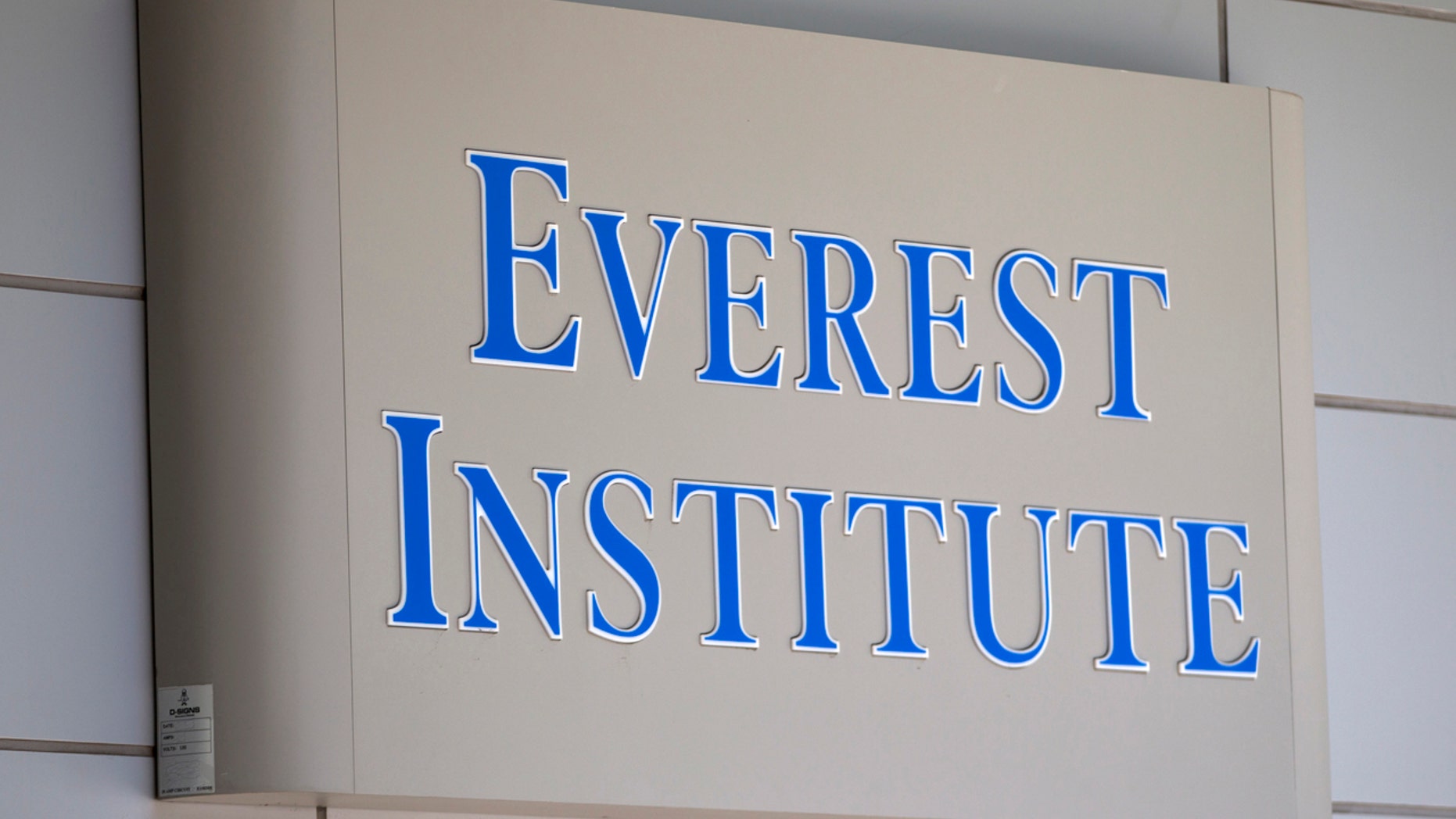 FILE - In this July 8, 2014 file photo, an Everest Institute sign is seen in a office building in Silver Spring, Md.