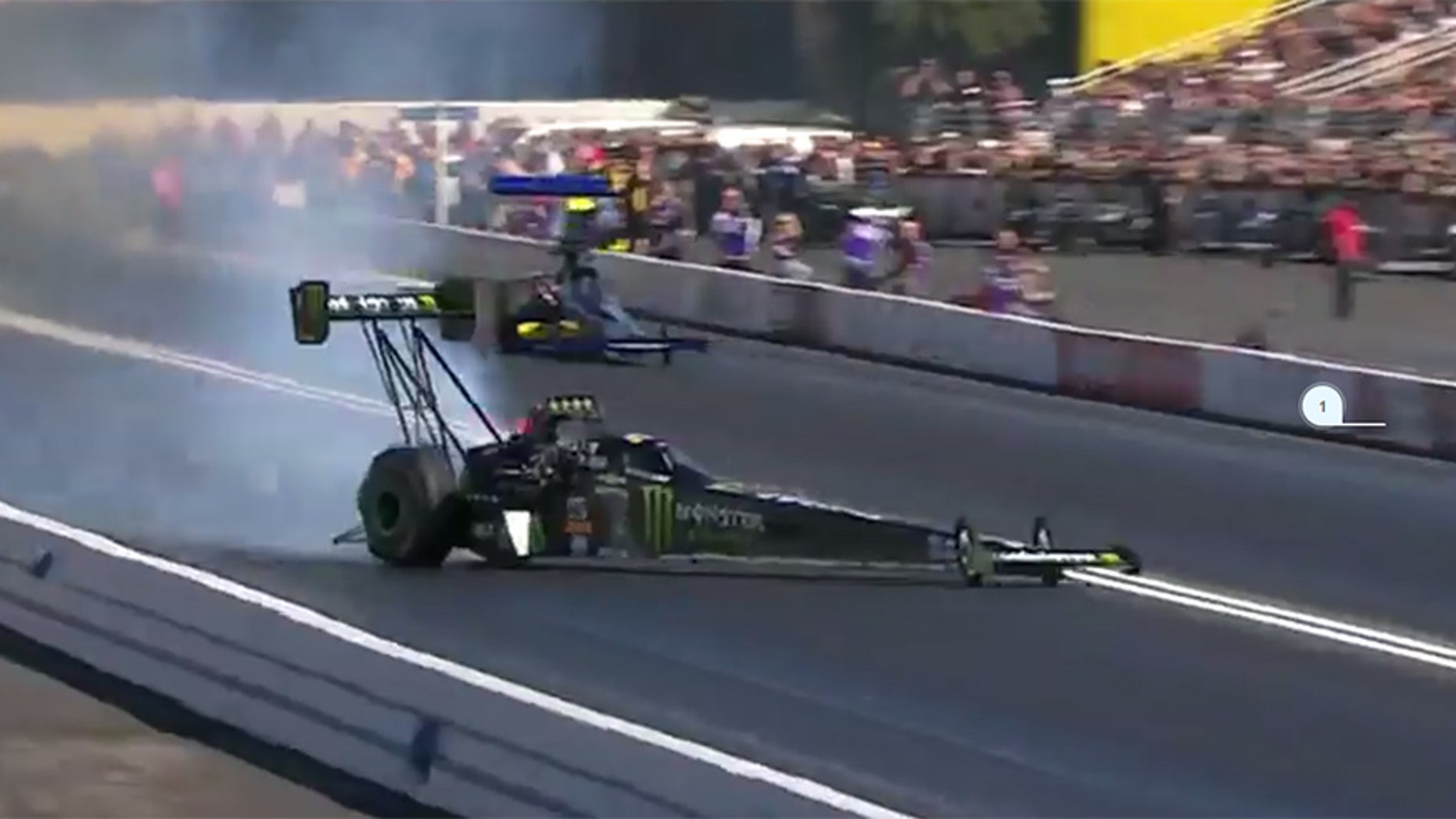 Emergency crews help Force from her Top Fuel dragster.