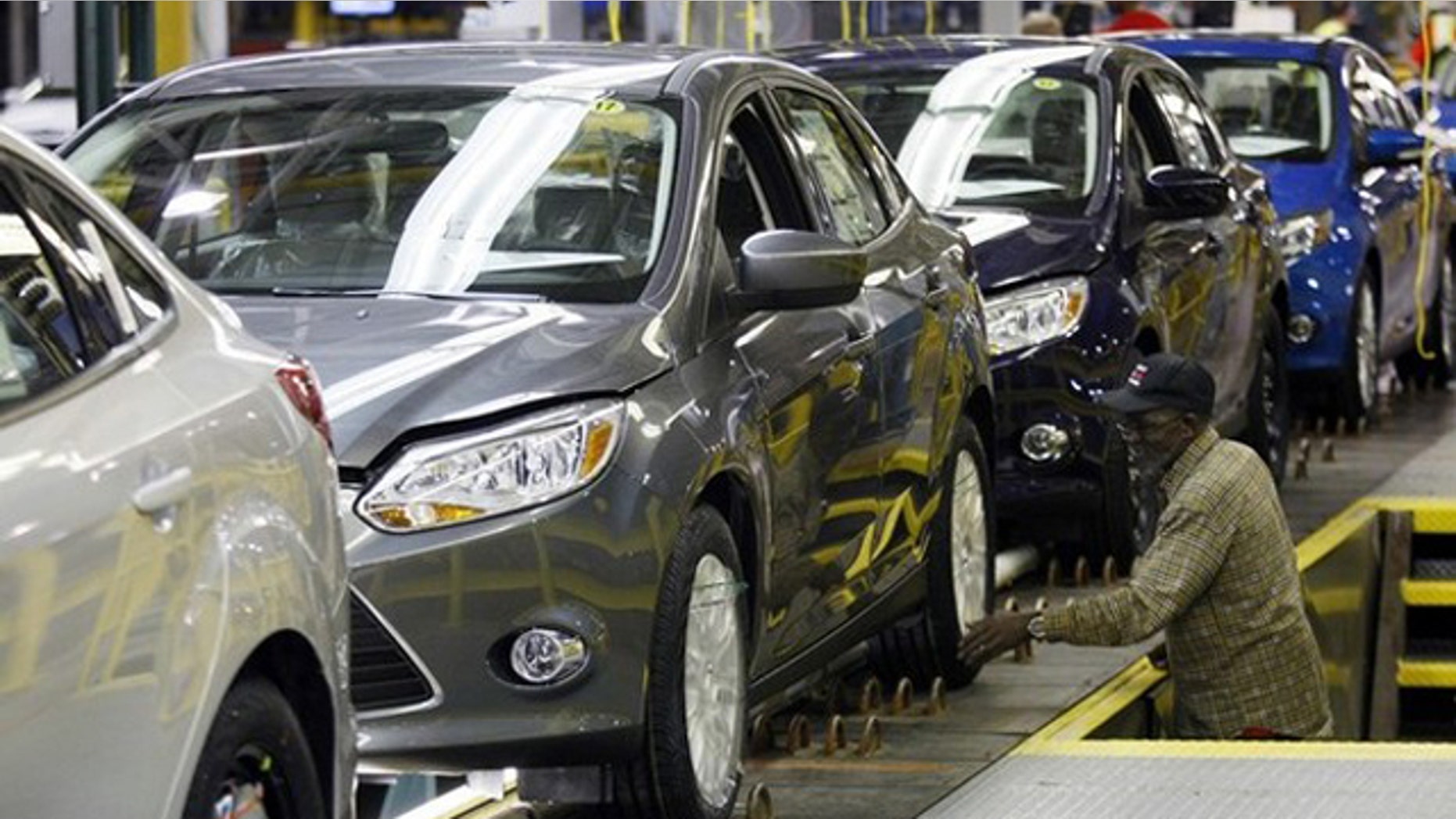A Ford employee works on the final production line of the 2012 Ford Focus at Michigan Assembly Plant in Wayne, Mich., March 17.