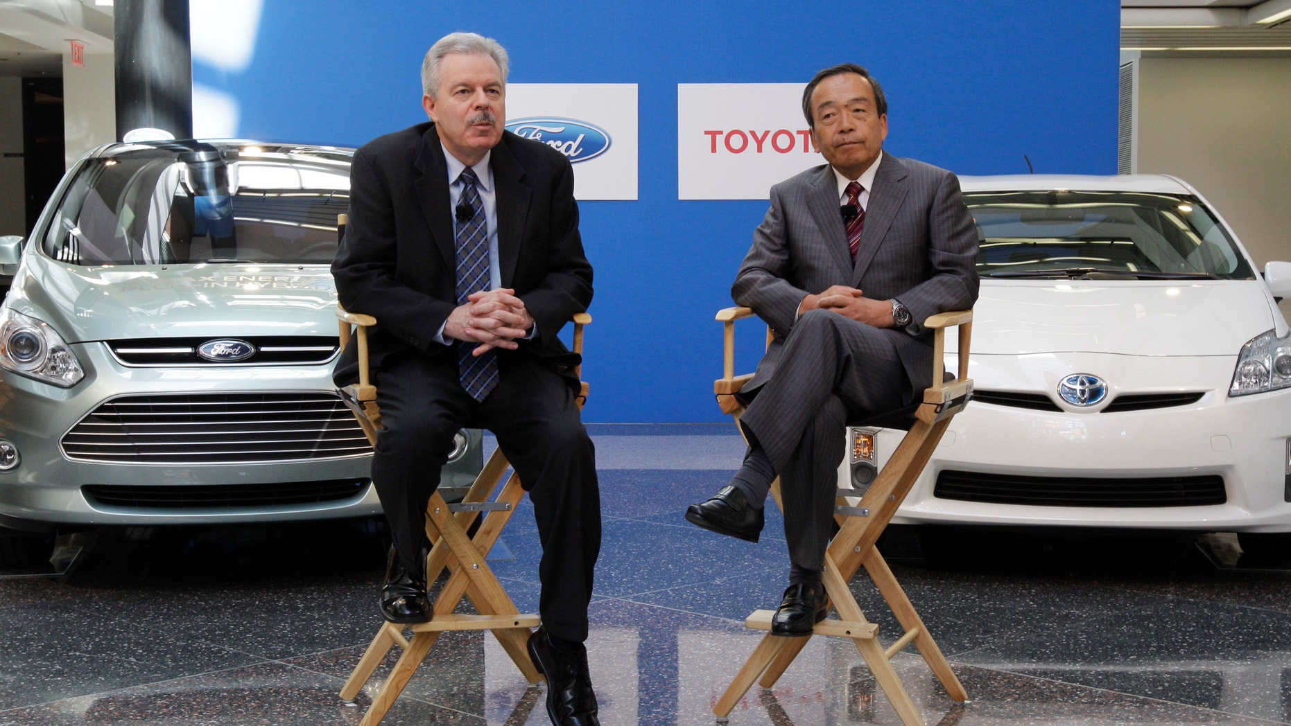 Derrick Kuzak, Ford Motor Company group vice president, Global Product Development, left, and Takeshi Uchiyamada, Toyota Motor Corporation executive vice president, Research & Development shake hands at a news conference in Dearborn, Mich., Monday, Aug. 22, 2011. The automakers announced they will equally collaborate on the development of an advanced new hybrid System for light truck and SUV customers. (AP Photo/Paul Sancya)