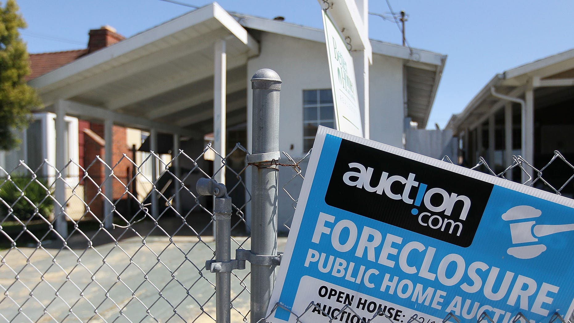 RICHMOND, CA - APRIL 06: A foreclosure sign hangs on a fence in front of a foreclosed home on April 6, 2011 in Richmond, California. The California Housing Finance Agency is expanding its $2 billion foreclosure relief initiative that will now help those who refinanced or took out home equity lines of credit. The agency's largest program offers $875 million in temporary financial help to people who have lost their jobs or had pay reductions and will provide up to $3,000 a month for six months to cover mortgatge payments and related costs. (Photo by Justin Sullivan/Getty Images)