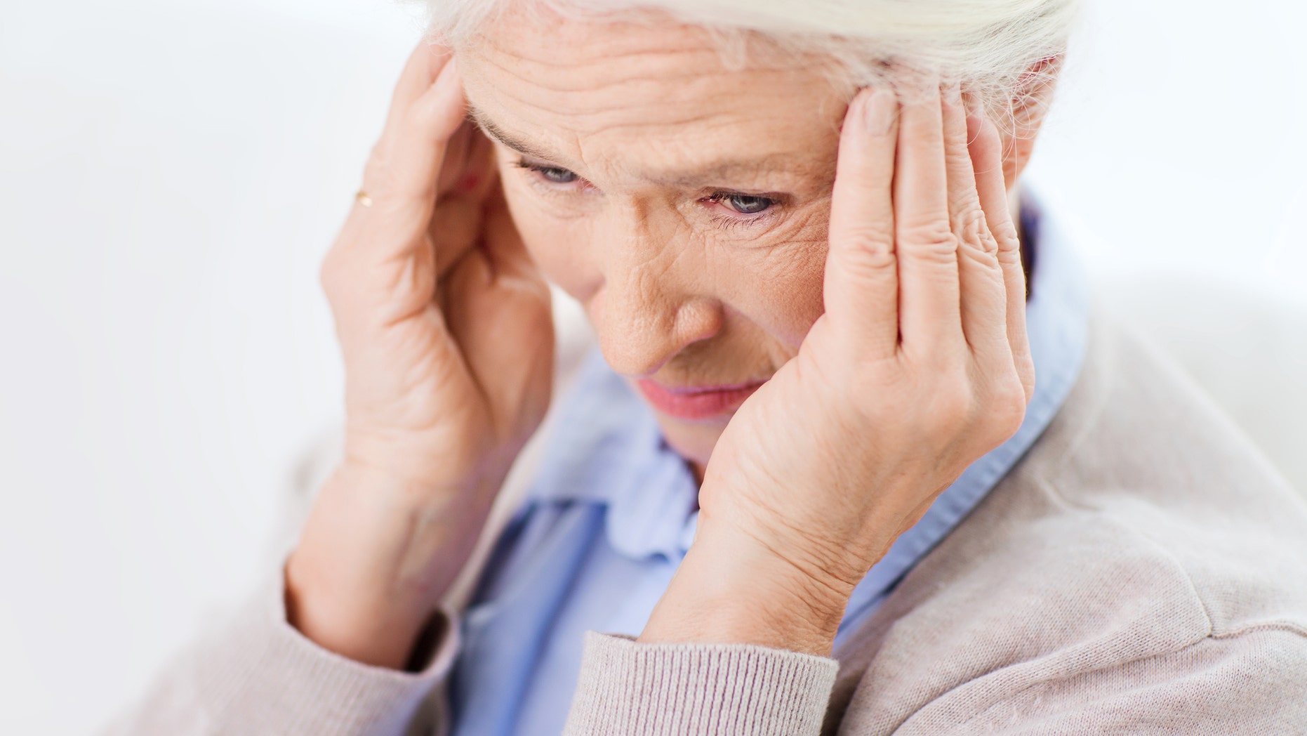 health care, pain, stress, age and people concept - face of senior woman suffering from headache
