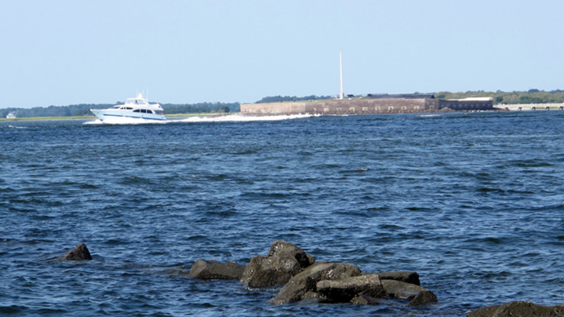 A pleasure boat motors past Fort Sumter in this Friday, Sept. 9, 2016, photograph taken from the beach on Sullivans Island, S.C.