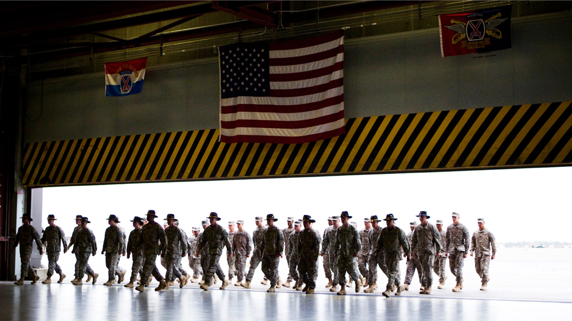 Soldiers from the 10th Combat Aviation Brigade walk into a ceremony at Fort Drum as they return from a yearlong tour in Afghanistan.